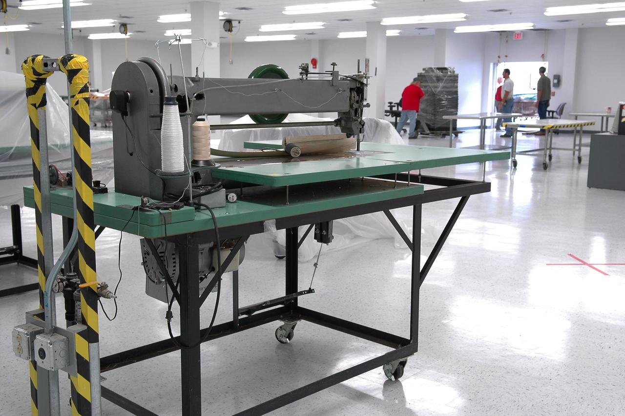 KENNEDY SPACE CENTER, FLA. - One of the blanket sewing machines used on Thermal Protection System materials has been returned to the TPS facility.  It was moved to the RLV Hangar at NASA Kennedy Space Center after the 2004 hurricanes damaged the upper floor, where soft material was processed, of the TPS facility.   While the TPS facility was being repaired, normal work activity was done in the hangar.