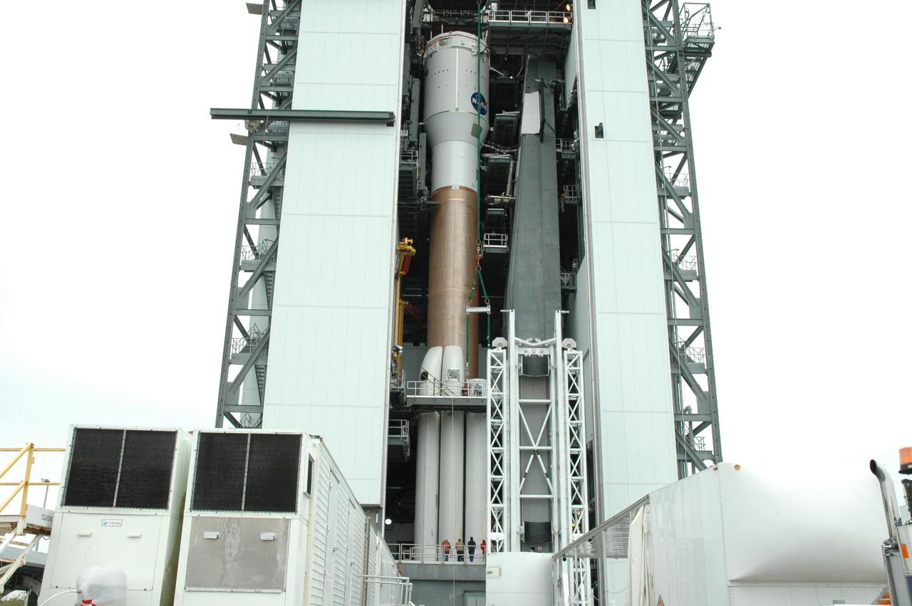 KENNEDY SPACE CENTER, FLA. - On Launch Complex 41 at Cape Canaveral Air Force Station in Florida, the five solid rocket boosters are now mated with the Lockheed Martin Atlas V rocket in the Vertical Integration Facility. The Atlas V is the launch vehicle for the Pluto-bound New Horizons spacecraft that will make the first reconnaissance of Pluto and its moon, Charon - a "double planet" and the last planet in our solar system to be visited by spacecraft. As it approaches Pluto, the spacecraft will look for ultraviolet emission from Pluto's atmosphere and make the best global maps of Pluto and Charon in green, blue, red and a special wavelength that is sensitive to methane frost on the surface. It will also take spectral maps in the near infrared, telling the science team about Pluto's and Charon’s surface compositions and locations and temperatures of these materials. When the spacecraft is closest to Pluto or its moon, it will take close-up pictures in both visible and near-infrared wavelengths. The mission will then visit one or more objects in the Kuiper Belt region beyond Neptune. New Horizons is scheduled to launch in January 2006, swing past Jupiter for a gravity boost and scientific studies in February or March 2007, and reach Pluto and Charon in July 2015.