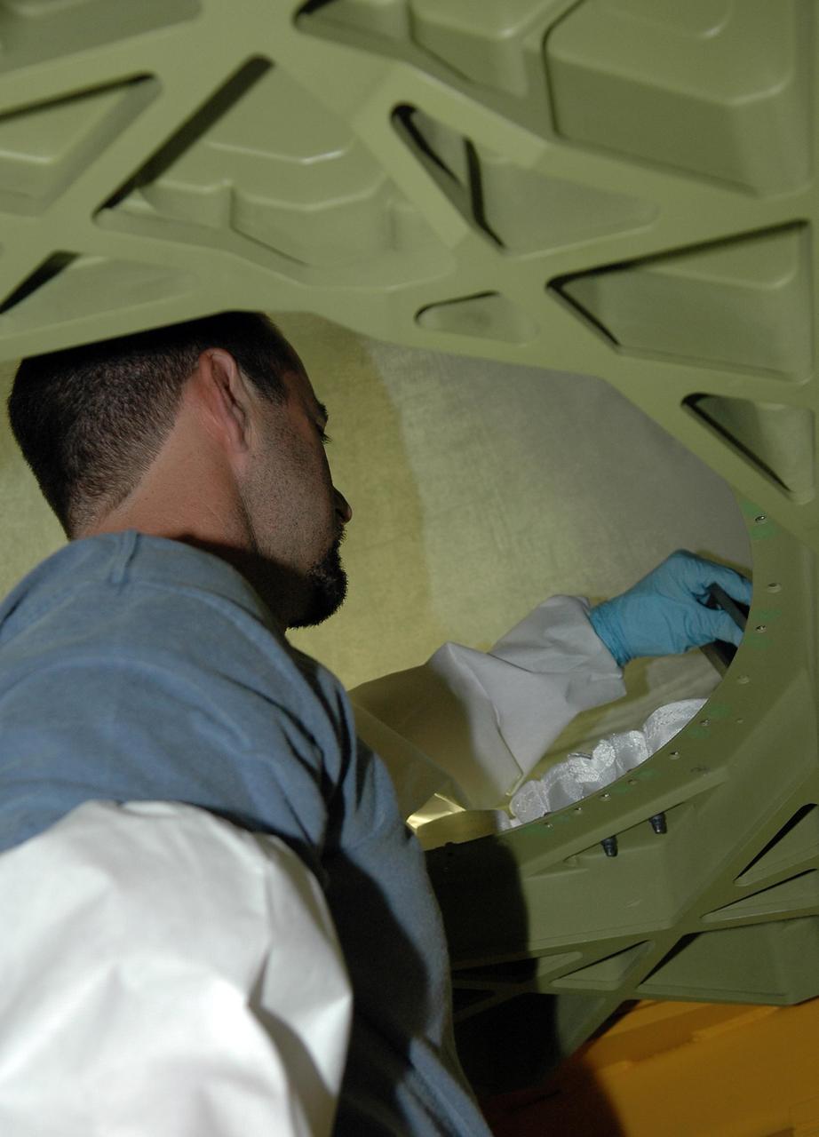 KENNEDY SPACE CENTER, FLA. -   In Orbiter Processing Facility Bay 2, United Space Alliance technician Michael Vanwart installs thermal protection system blankets in the nose cap of space shuttle Endeavour. Endeavour recently came out of a nearly two-year Orbiter Major Modification period which began in December 2003. Engineers and technicians spent 900,000 hours performing 124 modifications to the vehicle. These included all recommended return-to-flight safety modifications, bonding more than 1,000 thermal protection system tiles and inspecting more than 150 miles of wiring throughout the orbiter. Shuttle major modification periods are scheduled at regular intervals to enhance safety and performance, infuse new technology, and allow for thorough inspections of the airframe and wiring of the vehicles. This was the second of these modification periods performed entirely at Kennedy Space Center. Endeavour's previous modification was completed in March 1997.