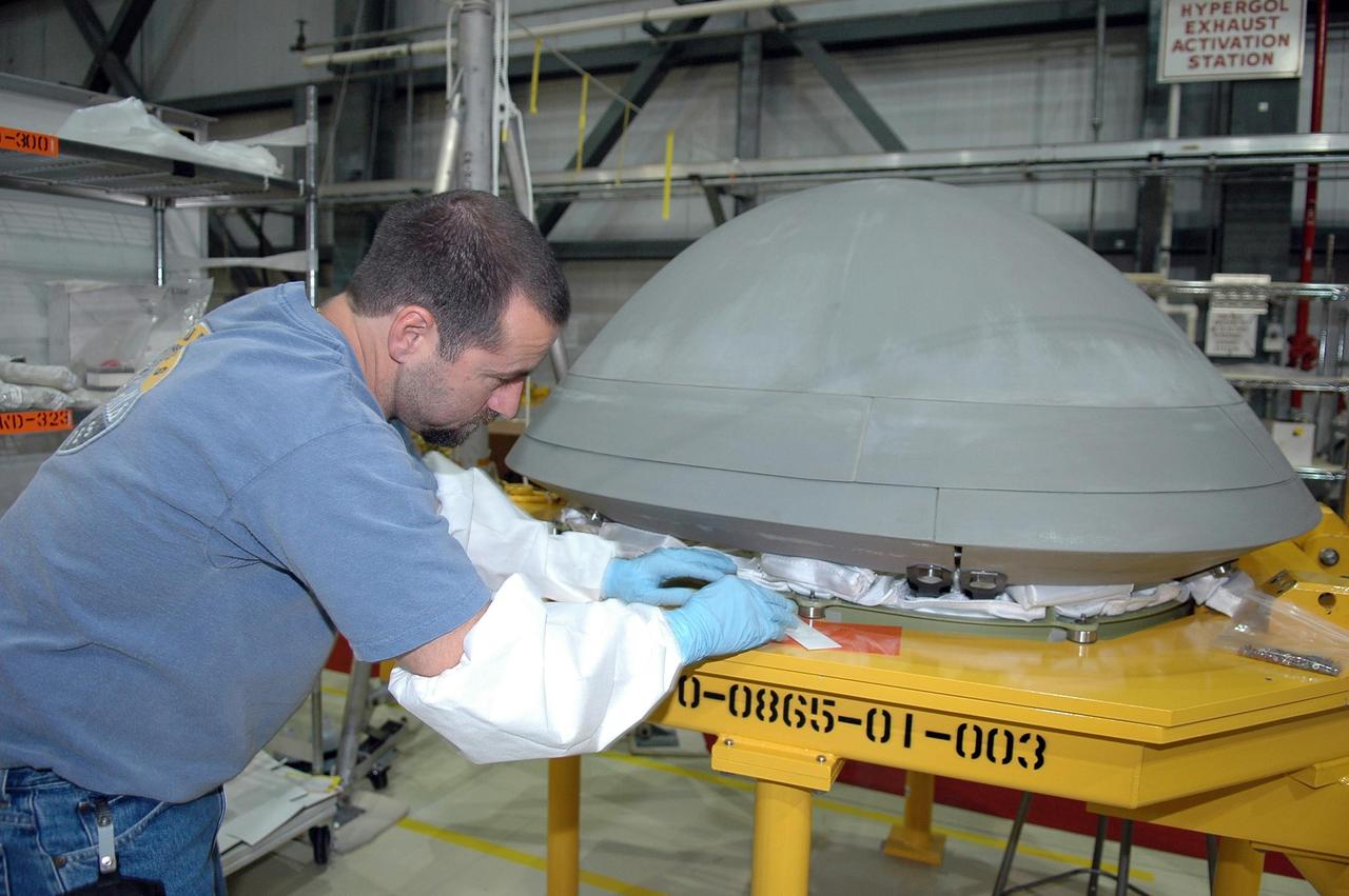 KENNEDY SPACE CENTER, FLA. -   In Orbiter Processing Facility Bay 2, United Space Alliance technician Michael Vanwart installs thermal protection system blankets in the nose cap of space shuttle Endeavour. Endeavour recently came out of a nearly two-year Orbiter Major Modification period which began in December 2003. Engineers and technicians spent 900,000 hours performing 124 modifications to the vehicle. These included all recommended return-to-flight safety modifications, bonding more than 1,000 thermal protection system tiles and inspecting more than 150 miles of wiring throughout the orbiter. Shuttle major modification periods are scheduled at regular intervals to enhance safety and performance, infuse new technology, and allow for thorough inspections of the airframe and wiring of the vehicles. This was the second of these modification periods performed entirely at Kennedy Space Center. Endeavour's previous modification was completed in March 1997.