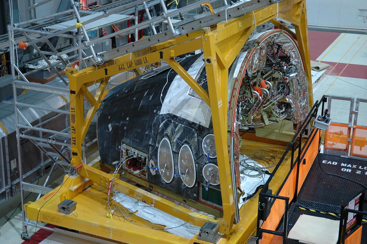 KENNEDY SPACE CENTER, FLA. - The Forward Reaction Control System (FRCS) of space shuttle Atlantis sits in the transfer aisle of Orbiter Processing Facility Bay 1 in anticipation of being installed. The FRCS provides the thrust for attitude (rotational) maneuvers (pitch, yaw and roll) and for small velocity changes along the orbiter axis (translation maneuvers). Processing of Atlantis is under way for mission STS-115, the 19th flight to the International Space Station.