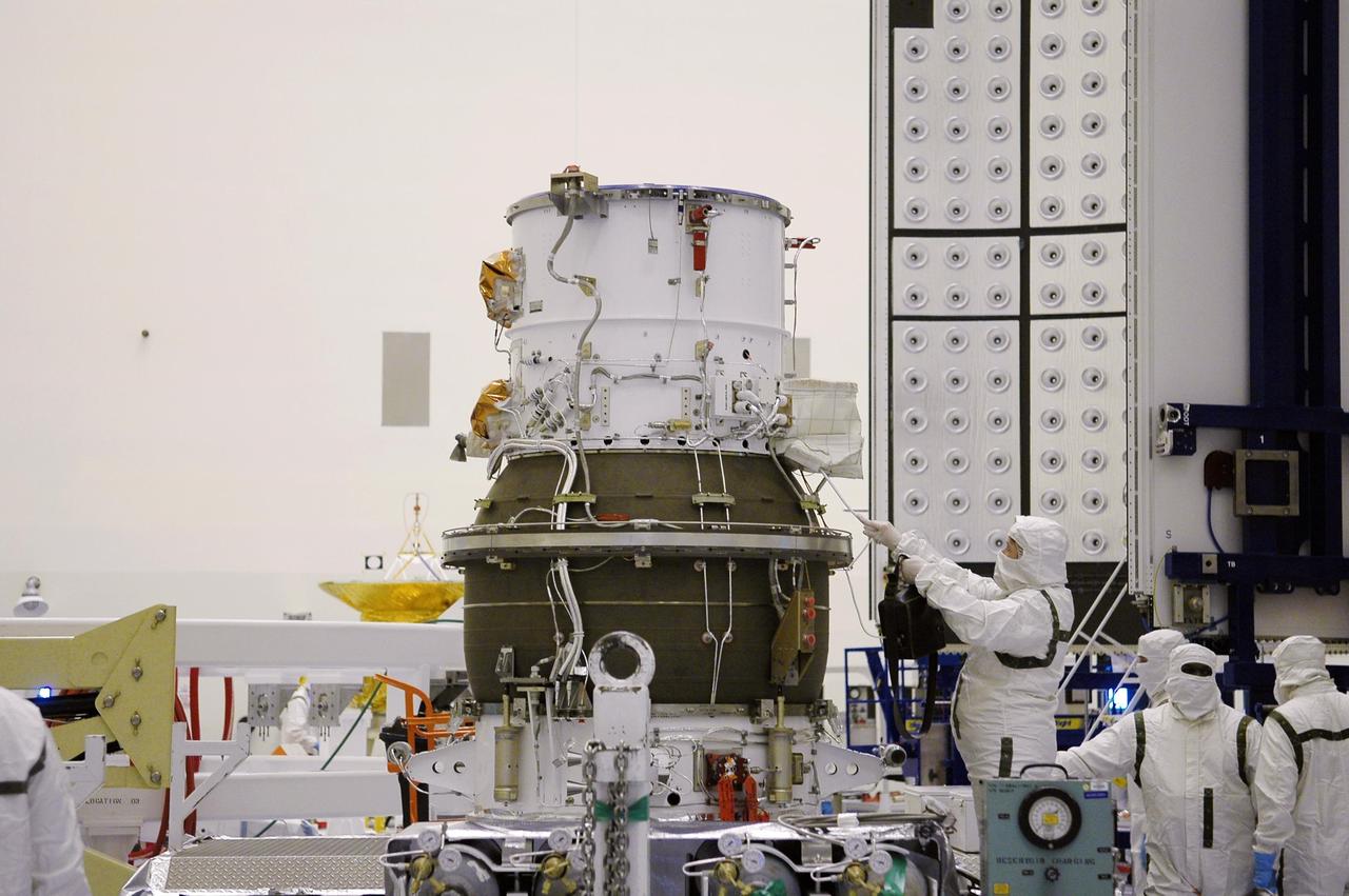 KENNEDY SPACE CENTER, FLA. -   In NASA Kennedy Space Center’s Payload Hazardous Servicing Facility, Boeing workers garbed in clean room suits get ready to move the third stage, or upper stage for the New Horizons spacecraft. The third stage is a Boeing STAR 48 solid-propellant kick motor.  The launch vehicle for New Horizons is the Atlas V rocket, scheduled to launch from Cape Canaveral Air Force Station, Fla., during a 35-day window that opens Jan. 11, and fly through the Pluto system as early as summer 2015.