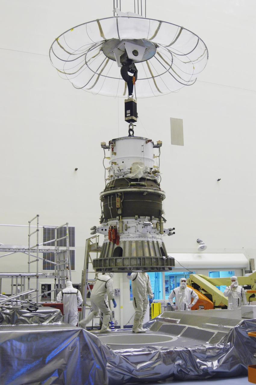 KENNEDY SPACE CENTER, FLA. -  In NASA Kennedy Space Center’s Payload Hazardous Servicing Facility, the third stage, or upper stage for the New Horizons spacecraft is lifted from its transporter.  The third stage, a Boeing STAR 48 solid-propellant kick motor, is being moved to a work stand.  The launch vehicle for New Horizons is the Atlas V rocket, scheduled to launch from Cape Canaveral Air Force Station, Fla., during a 35-day window that opens Jan. 11, and fly through the Pluto system as early as summer 2015.
