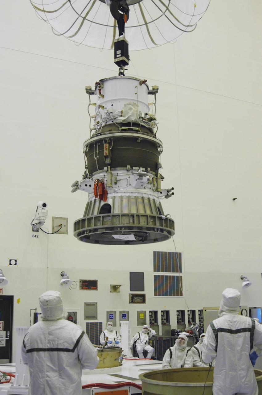 KENNEDY SPACE CENTER, FLA. -  In NASA Kennedy Space Center’s Payload Hazardous Servicing Facility, the third stage, or upper stage for the New Horizons spacecraft is lifted from its transporter.  The third stage, a Boeing STAR 48 solid-propellant kick motor, is being moved to a work stand, in the foreground at right.  The launch vehicle for New Horizons is the Atlas V rocket, scheduled to launch from Cape Canaveral Air Force Station, Fla., during a 35-day window that opens Jan. 11, and fly through the Pluto system as early as summer 2015.