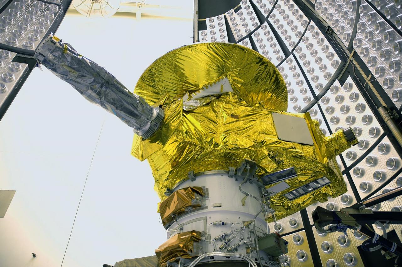 KENNEDY SPACE CENTER, FLA. - In the Payload Hazardous Servicing Facility, the two fairing sections move into place around the New Horizons spacecraft for encapsulation. The fairing protects the spacecraft during launch and flight through the atmosphere. Once out of the atmosphere, the fairing is jettisoned. The compact 1,060-pound New Horizons probe carries seven scientific instruments that will characterize the global geology and geomorphology of Pluto and its moon Charon, map their surface compositions and temperatures, and examine Pluto's complex atmosphere. After that, flybys of Kuiper Belt objects from even farther in the solar system may be undertaken in an extended mission. New Horizons is the first mission in NASA's New Frontiers program of medium-class planetary missions. The spacecraft, designed for NASA by the Johns Hopkins University Applied Physics Laboratory in Laurel, Md., will fly by Pluto and Charon as early as summer 2015.