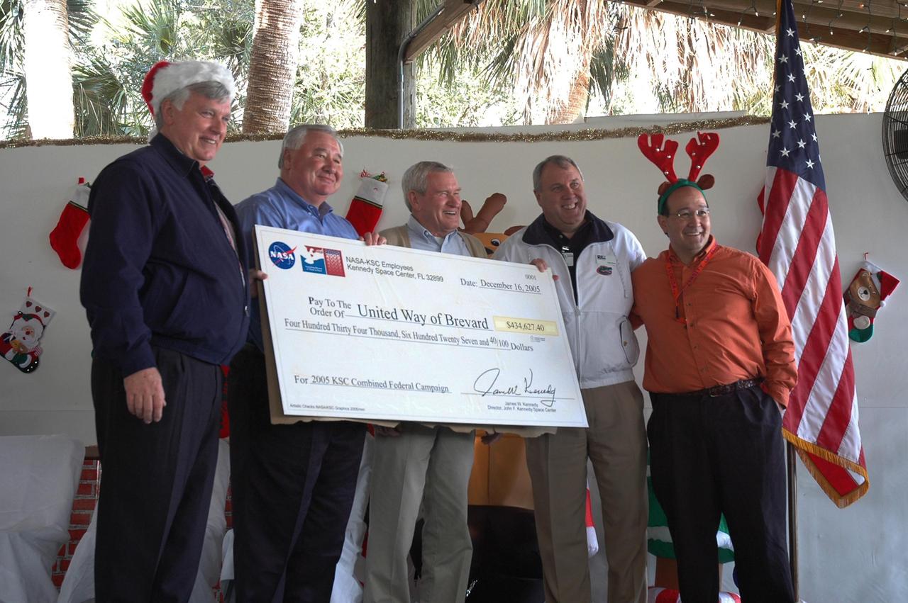 KENNEDY SPACE CENTER, FLA. - An oversized $434,627.40 check represents the highest amount the NASA civil service work force has ever donated to the Combined Federal Campaign. Standing with the check, from left, are Center Director Jim Kennedy; Dennis Burns, United Way of Brevard, vice president of resource development; Frank Ramsey, United Way of Brevard campaign director; Rob Rains, United Way of Brevard president; and Launch Services Program deputy director Ray Lugo, who served as KSC's Combined Federal Campaign chairperson. The check was presented at a holiday dinner and celebration at KARS Park I on Merritt Island, Fla., hosted by Center Director Jim Kennedy for NASA civil service employees. The theme of the celebration was "Launching Dreams of Those in Need." The event was sponsored by the Change Leaders Network and the Combined Federal Campaign Cabinet.