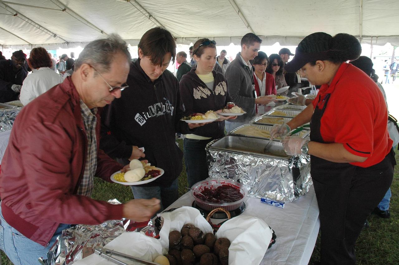 KENNEDY SPACE CENTER, FLA. - NASA Civil Service employees and their families enjoy a traditional holiday meal of turkey, ham and all of the trimmings at an annual holiday dinner and celebration hosted by Center Director Jim Kennedy, at KARS Park 1 on Merritt Island, Fla. The theme for the celebration was "Launching Dreams of Those in Need." The event was sponsored by the Change Leaders Network and the Combined Federal Campaign Cabinet.