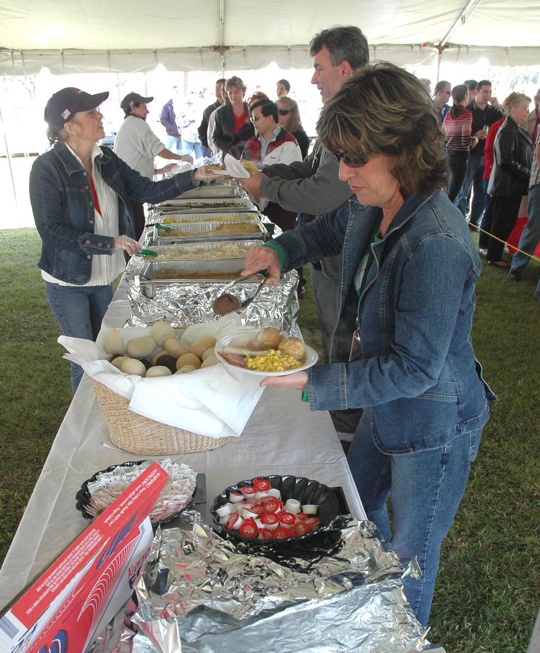 KENNEDY SPACE CENTER, FLA. - NASA Civil Service employees and their families help themselves to a traditional holiday meal of turkey, ham and all of the trimmings at an annual holiday dinner and celebration hosted by Center Director Jim Kennedy, at KARS Park 1 on Merritt Island, Fla. The theme for the celebration was "Launching Dreams of Those in Need." The event was sponsored by the Change Leaders Network and the Combined Federal Campaign Cabinet.