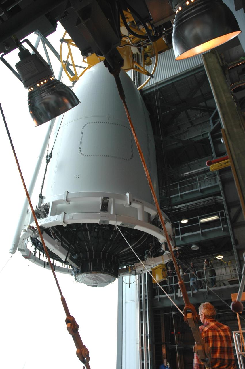 KENNEDY SPACE CENTER, FLA. - The fairing enclosing New Horizons arrives at the top of a Lockheed Martin Atlas V launch vehicle in the Vertical Integration Facility at Complex 41 on Cape Canaveral Air Force Station. New Horizons carries seven scientific instruments that will characterize the global geology and geomorphology of Pluto and its moon Charon, map their surface compositions and temperatures, and examine Pluto's complex atmosphere. After that, flybys of Kuiper Belt objects from even farther in the solar system may be undertaken in an extended mission. New Horizons is the first mission in NASA's New Frontiers program of medium-class planetary missions. The spacecraft, designed for NASA by the Johns Hopkins University Applied Physics Laboratory in Laurel, Md., will launch aboard a Lockheed Martin Atlas V rocket and fly by Pluto and Charon as early as summer 2015.