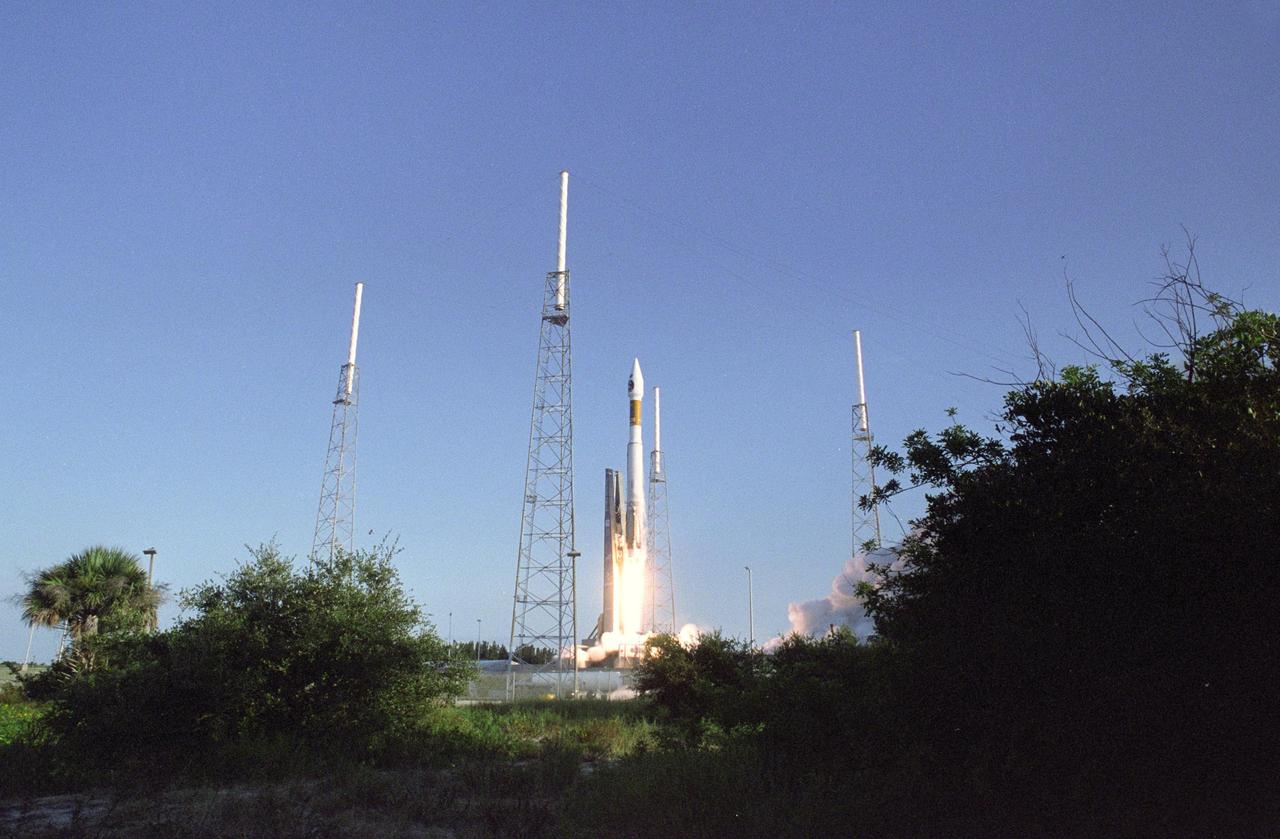 KENNEDY SPACE CENTER, FLA. -    Viewed through a break in the greenscape around Launch Complex 41 at Cape Canaveral Air Force Station in Florida, the 19-stories-tall Atlas V launch vehicle roars off the launch pad, propelling the two-ton Mars Reconnaissance Orbiter (MRO) into a clear blue Florida sky and eventual orbit around Mars.  Liftoff was at 7:43 a.m. EDT. All systems performed nominally for NASA's first launch of an Atlas V on an interplanetary mission. MRO established radio contact with controllers 61 minutes after launch and within four minutes of separation from the upper stage. Initial contact came through an antenna at the Japan Aerospace Exploration Agency's Uchinoura Space Center in southern Japan. Mars is 72 million miles from Earth today, but the spacecraft will travel more than four times that distance on its outbound-arc trajectory to intercept the red planet on March 10, 2006. The orbiter carries six scientific instruments for examining the surface, atmosphere and subsurface of Mars in unprecedented detail from low orbit. NASA expects to get several times more data about Mars from MRO than from all previous Martian missions combined. Researchers will use the instruments to learn more about the history and distribution of Mars' water. That information will improve understanding of planetary climate change and will help guide the quest to answer whether Mars ever supported life. The orbiter will also evaluate potential landing sites for future missions.