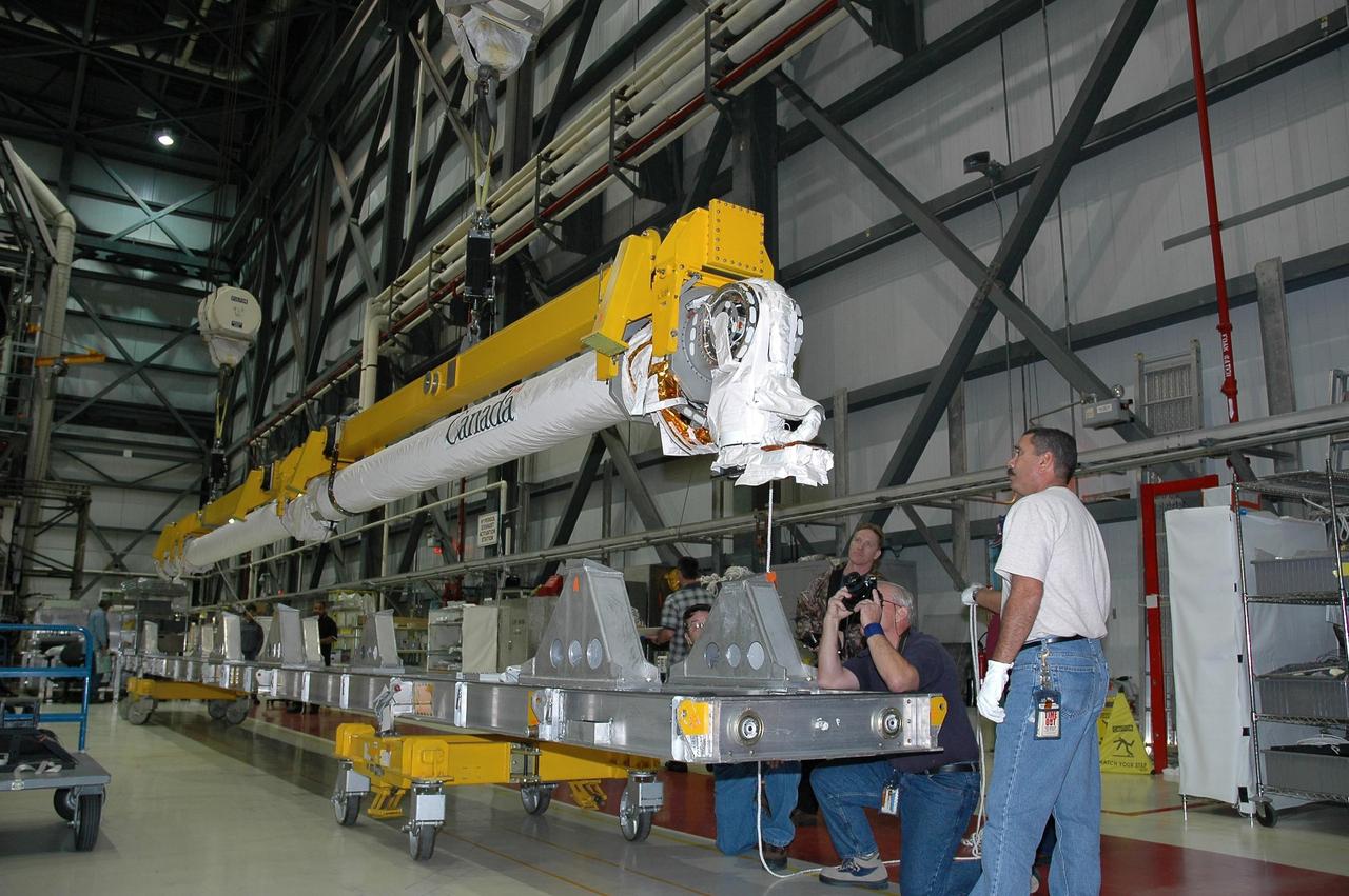 KENNEDY SPACE CENTER, FLA. -   In the Orbiter Processing Facility bay 1 at NASA Kennedy Space Center, the remote manipulator system, or boom, is lifted off a stand via overhead cranes.  The boom will be installed in Atlantis’ payload bay. Atlantis is the designated orbiter for mission STS-115, the 19th assembly flight to the International Space Station.  The payload includes the P3/P4 solar arrays. The launch planning window has not been determined yet for STS-115.