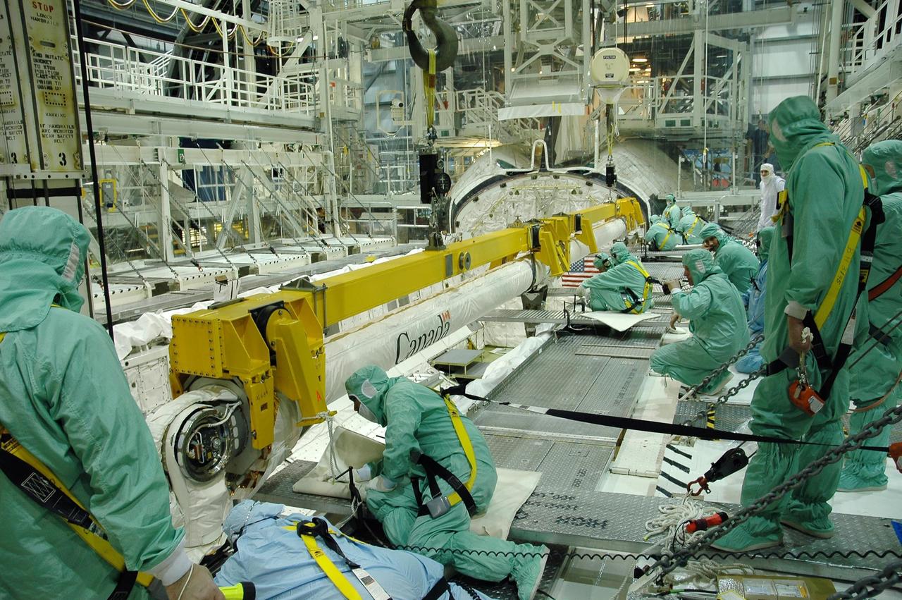 KENNEDY SPACE CENTER, FLA. -  In the Orbiter Processing Facility bay 1 at NASA Kennedy Space Center, engineers begin attaching the remote manipulator system, or boom, in Atlantis’ payload bay.  Atlantis is the designated orbiter for mission STS-115, the 19th assembly flight to the International Space Station.  The payload includes the P3/P4 solar arrays. The launch planning window has not been determined yet for STS-115.