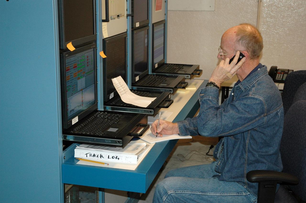 KENNEDY SPACE CENTER, FLA. -  Chuck Demming, with Northrop Grumman, works the console responsible for operation of the C-band, 3 megawatt radar and 50-foot dish antenna recently installed on north Kennedy Space Center.  The radar is is one of the largest of its kind in the world, providing higher definition imagery than has ever been available before.  Working in concert with two new NASA-owned X-band radars mounted on the solid rocket booster retrieval ships, tracking the space shuttle and expendable launch vehicles with this new capability will provide more detail than NASA has ever observed by radar before.  The first use of this C-band radar will be for the launch of the Atlas V rocket sending the New Horizons probe toward Pluto.  The radar is operated under a NASA contract with the U.S. Navy, who owns the radar.  Photo credit: NASA/George Shelton/Demitrius Gerondidakas