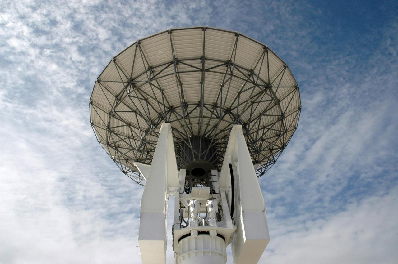 KENNEDY SPACE CENTER, FLA. -  Stretching into the cloud-streaked sky is this new C-band, 3 megawatt radar with a 50-foot dish antenna recently installed on north Kennedy Space Center.  It is one of the largest of its kind in the world, providing higher definition imagery than has ever been available before.  Working in concert with two new NASA-owned X-band radars mounted on the solid rocket booster retrieval ships, tracking the space shuttle and expendable launch vehicles with this new capability will provide more detail than NASA has ever observed by radar before.  The first use of this C-band radar will be for the launch of the Atlas V rocket sending the New Horizons probe toward Pluto.  The radar is operated under a NASA contract with the U.S. Navy who owns the radar.