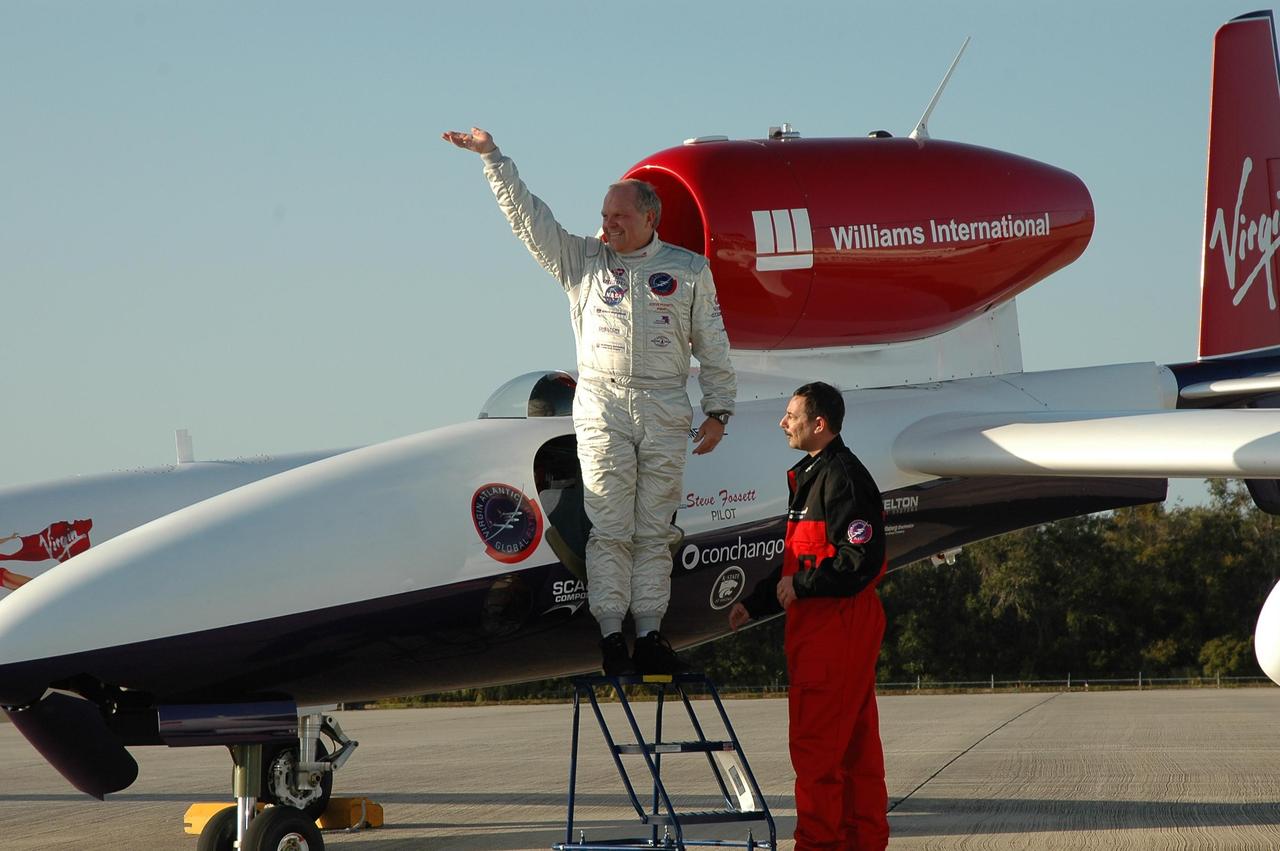 KENNEDY SPACE CENTER, FLA. -   Pilot Steve Fossett waves as he leaves the cockpit of the Virgin Atlantic Airways GlobalFlyer aircraft, which he landed at NASA Kennedy Space Center’s Shuttle Landing Facility.  The aircraft is being relocated from Salina, Kan., to the Shuttle Landing Facility to begin preparations for an attempt to set a new world record for the longest flight made by any aircraft. An exact takeoff date for the record-setting flight has not been determined and is contingent on weather and jet-stream conditions. The window for the attempt opens in mid-January, making the flight possible anytime between then and the end of February.  NASA agreed to let Virgin Atlantic Airways use Kennedy's Shuttle Landing Facility as a takeoff site. The facility use is part of a pilot program to expand runway access for non-NASA activities.