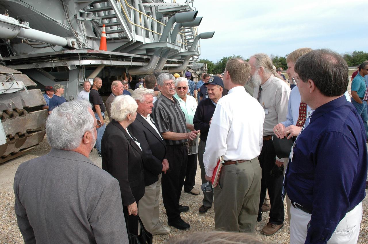 KENNEDY SPACE CENTER, FLA. - On the occasion of the 40th anniversary of the crawler transporter used for moving space shuttles to the NASA Kennedy Space Center’s launch pads, invited guests mingle in front of one of the crawlers still in use. From left are Sylvan “Skip” Montagna, Patricia and Fred Renaud, Fred Wallace and Bill Clemens. Philip Koehring and his brothers Doug(white shirt) and John (light blue shirt) and Rick Drollinger are on the right. Philip Koehring Sr. was project manager at the Marion Power Shovel Co. in Ohio where the crawlers were initially built in 1965. Drollinger’s father, Richard, was director of engineering at Marion. Media representatives and invited guests had the opportunity to tour one of NASA's two crawlers. This included the driver cab and engine room. Guests included current drivers and operators, as well as drivers from the Apollo Program. In January 1966, the crawler completed its first successful move with a 10.6-million-pound launch umbilical tower. It moved three-quarters of a mile in about nine hours. Throughout 40 years of service, the two crawlers have moved more than 3,500 miles and carried seven vehicles.