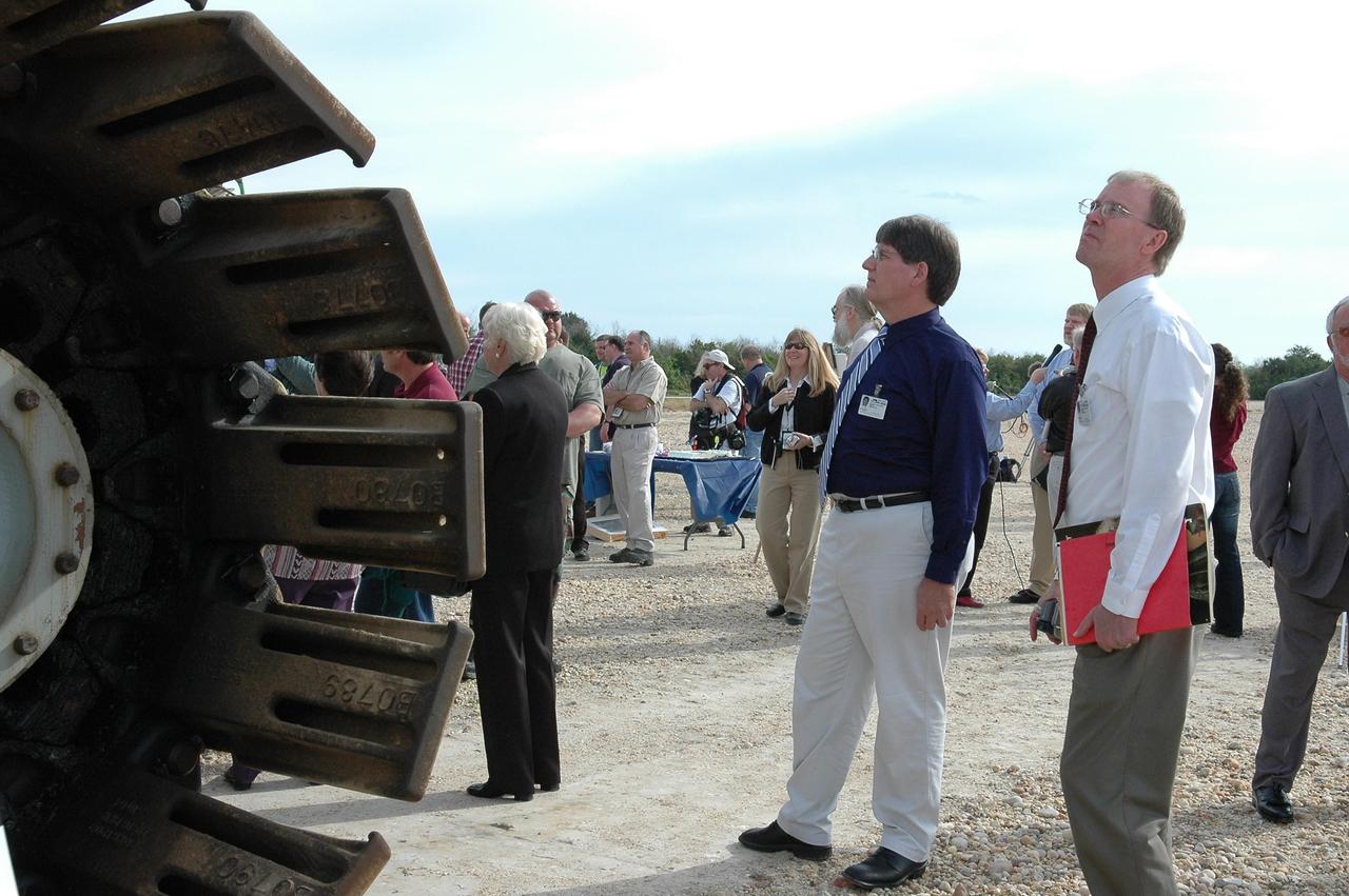 KENNEDY SPACE CENTER, FLA. - On the occasion of the 40th anniversary of the crawler transporter used for moving space shuttles to the NASA Kennedy Space Center’s launch pads, Rick Drollinger (center) and John Koehring get a close look at one of the crawlers still in use. Drollinger’s father, Richard, was director of engineering at Marion Power Shovel Co. in Ohio where the crawlers were initially built in 1965. Koehring is the son of Philip Koehring Sr., who was project manager at Marion. Media representatives and invited guests had the opportunity to tour one of NASA's two crawlers. This included the driver cab and engine room. Guests included current drivers and operators, as well as drivers from the Apollo Program. In January 1966, the crawler completed its first successful move with a 10.6-million-pound launch umbilical tower. It moved three-quarters of a mile in about nine hours. Throughout 40 years of service, the two crawlers have moved more than 3,500 miles and carried seven vehicles.