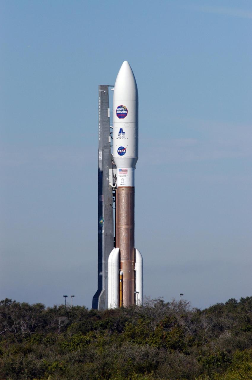 KENNEDY SPACE CENTER, FLA. - On Complex 41 at Cape Canaveral Air Force Station, the Atlas V expendable launch vehicle with the New Horizons spacecraft moves with the launcher umbilical tower to the pad. The liftoff is scheduled for 1:24 p.m. EST Jan. 17. After its launch aboard the Atlas V, the compact, 1,050-pound piano-sized probe will get a boost from a kick-stage solid propellant motor for its journey to Pluto. New Horizons will be the fastest spacecraft ever launched, reaching lunar orbit distance in just nine hours and passing Jupiter 13 months later. The New Horizons science payload, developed under direction of Southwest Research Institute, includes imaging infrared and ultraviolet spectrometers, a multi-color camera, a long-range telescopic camera, two particle spectrometers, a space-dust detector and a radio science experiment. The dust counter was designed and built by students at the University of Colorado, Boulder. A launch before Feb. 3 allows New Horizons to fly past Jupiter in early 2007 and use the planet’s gravity as a slingshot toward Pluto. The Jupiter flyby trims the trip to Pluto by as many as five years and provides opportunities to test the spacecraft’s instruments and flyby capabilities on the Jupiter system. New Horizons could reach the Pluto system as early as mid-2015, conducting a five-month-long study possible only from the close-up vantage of a spacecraft.