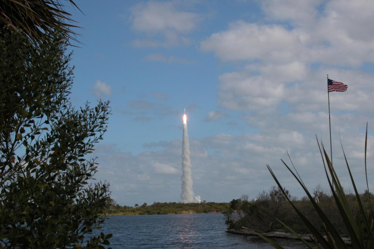 KENNEDY SPACE CENTER, FLA.  — Into a blue, cloud-scattered sky, NASA’s New Horizons spacecraft lifts off on time at 2 p.m. EST aboard an Atlas V rocket from Complex 41 on Cape Canaveral Air Force Station in Florida.  This was the third launch attempt in as many days after scrubs due to weather concerns.   The compact, 1,050-pound piano-sized probe will get a boost from a kick-stage solid propellant motor for its journey to Pluto. New Horizons will be the fastest spacecraft ever launched, reaching lunar orbit distance in just nine hours and passing Jupiter 13 months later. The New Horizons science payload, developed under direction of Southwest Research Institute, includes imaging infrared and ultraviolet spectrometers, a multi-color camera, a long-range telescopic camera, two particle spectrometers, a space-dust detector and a radio science experiment. The dust counter was designed and built by students at the University of Colorado, Boulder. The launch at this time allows New Horizons to fly past Jupiter in early 2007 and use the planet’s gravity as a slingshot toward Pluto. The Jupiter flyby trims the trip to Pluto by as many as five years and provides opportunities to test the spacecraft’s instruments and flyby capabilities on the Jupiter system. New Horizons could reach the Pluto system as early as mid-2015, conducting a five-month-long study possible only from the close-up vantage of a spacecraft.  Photo credit: NASA/Debbie Kiger