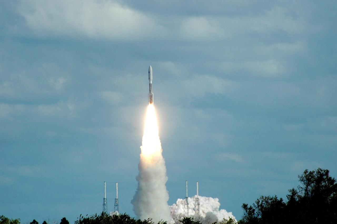 KENNEDY SPACE CENTER, FLA. — Leaping into a blue, cloud-scattered sky, NASA’s New Horizons spacecraft lifts off on time at 2 p.m. EST aboard an Atlas V rocket from Complex 41 on Cape Canaveral Air Force Station in Florida. This was the third launch attempt in as many days after scrubs due to weather concerns. The compact, 1,050-pound piano-sized probe will get a boost from a kick-stage solid propellant motor for its journey to Pluto. New Horizons will be the fastest spacecraft ever launched, reaching lunar orbit distance in just nine hours and passing Jupiter 13 months later. The New Horizons science payload, developed under direction of Southwest Research Institute, includes imaging infrared and ultraviolet spectrometers, a multi-color camera, a long-range telescopic camera, two particle spectrometers, a space-dust detector and a radio science experiment. The dust counter was designed and built by students at the University of Colorado, Boulder. The launch at this time allows New Horizons to fly past Jupiter in early 2007 and use the planet’s gravity as a slingshot toward Pluto. The Jupiter flyby trims the trip to Pluto by as many as five years and provides opportunities to test the spacecraft’s instruments and flyby capabilities on the Jupiter system. New Horizons could reach the Pluto system as early as mid-2015, conducting a five-month-long study possible only from the close-up vantage of a spacecraft. Photo credit: NASA/Ken Thornsley