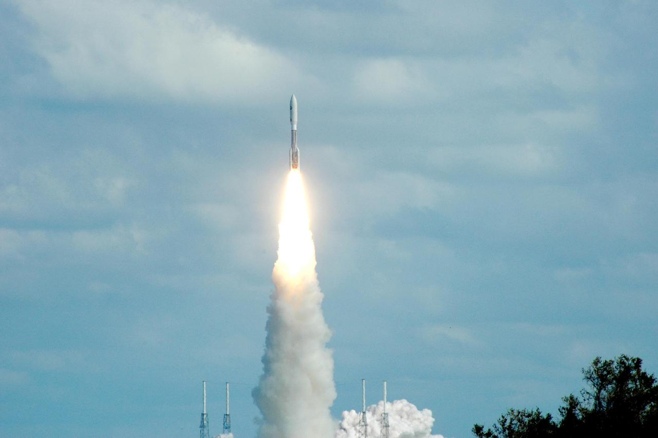 KENNEDY SPACE CENTER, FLA. — Into a blue, cloud-scattered sky, NASA’s New Horizons spacecraft lifts off on time at 2 p.m. EST aboard an Atlas V rocket from Complex 41 on Cape Canaveral Air Force Station in Florida This was the third launch attempt in as many days after scrubs due to weather concerns. The compact, 1,050-pound piano-sized probe will get a boost from a kick-stage solid propellant motor for its journey to Pluto. New Horizons will be the fastest spacecraft ever launched, reaching lunar orbit distance in just nine hours and passing Jupiter 13 months later. The New Horizons science payload, developed under direction of Southwest Research Institute, includes imaging infrared and ultraviolet spectrometers, a multi-color camera, a long-range telescopic camera, two particle spectrometers, a space-dust detector and a radio science experiment. The dust counter was designed and built by students at the University of Colorado, Boulder. The launch at this time allows New Horizons to fly past Jupiter in early 2007 and use the planet’s gravity as a slingshot toward Pluto. The Jupiter flyby trims the trip to Pluto by as many as five years and provides opportunities to test the spacecraft’s instruments and flyby capabilities on the Jupiter system. New Horizons could reach the Pluto system as early as mid-2015, conducting a five-month-long study possible only from the close-up vantage of a spacecraft. Photo credit: NASA/Ken Thornsley