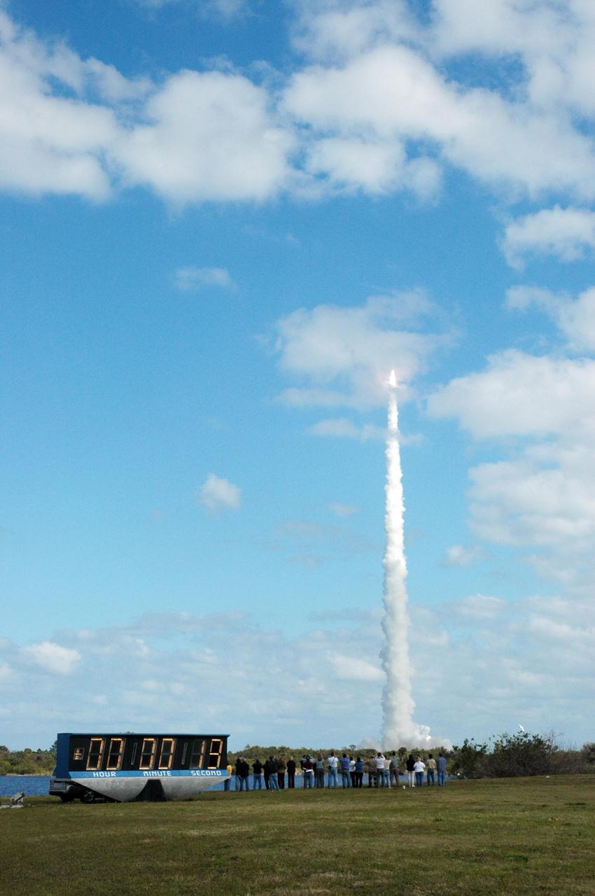 KENNEDY SPACE CENTER, FLA. — Viewed from the NASA News Center, NASA’s New Horizons spacecraft roars into the cloud-scattered sky trailing fire and smoke from the Atlas V rocket that propels it. Liftoff was on time at 2 p.m. EST from Complex 41 on Cape Canaveral Air Force Station in Florida. This was the third launch attempt in as many days after scrubs due to weather concerns. The compact, 1,050-pound piano-sized probe will get a boost from a kick-stage solid propellant motor for its journey to Pluto. New Horizons will be the fastest spacecraft ever launched, reaching lunar orbit distance in just nine hours and passing Jupiter 13 months later. The New Horizons science payload, developed under direction of Southwest Research Institute, includes imaging infrared and ultraviolet spectrometers, a multi-color camera, a long-range telescopic camera, two particle spectrometers, a space-dust detector and a radio science experiment. The dust counter was designed and built by students at the University of Colorado, Boulder. The launch at this time allows New Horizons to fly past Jupiter in early 2007 and use the planet’s gravity as a slingshot toward Pluto. The Jupiter flyby trims the trip to Pluto by as many as five years and provides opportunities to test the spacecraft’s instruments and flyby capabilities on the Jupiter system. New Horizons could reach the Pluto system as early as mid-2015, conducting a five-month-long study possible only from the close-up vantage of a spacecraft. Photo credit: NASA/Fletch Hildreth