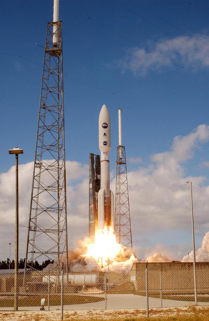 KENNEDY SPACE CENTER, FLA.  —   From between lightning masts surrounding the launch pad, NASA’s New Horizons spacecraft roars into the blue sky aboard an Atlas V rocket spewing flames and smoke.  Liftoff was on time at 2 p.m. EST from Complex 41 on Cape Canaveral Air Force Station in Florida.  This was the third launch attempt in as many days after scrubs due to weather concerns.   The compact, 1,050-pound piano-sized probe will get a boost from a kick-stage solid propellant motor for its journey to Pluto. New Horizons will be the fastest spacecraft ever launched, reaching lunar orbit distance in just nine hours and passing Jupiter 13 months later. The New Horizons science payload, developed under direction of Southwest Research Institute, includes imaging infrared and ultraviolet spectrometers, a multi-color camera, a long-range telescopic camera, two particle spectrometers, a space-dust detector and a radio science experiment. The dust counter was designed and built by students at the University of Colorado, Boulder. The launch at this time allows New Horizons to fly past Jupiter in early 2007 and use the planet’s gravity as a slingshot toward Pluto. The Jupiter flyby trims the trip to Pluto by as many as five years and provides opportunities to test the spacecraft’s instruments and flyby capabilities on the Jupiter system. New Horizons could reach the Pluto system as early as mid-2015, conducting a five-month-long study possible only from the close-up vantage of a spacecraft.