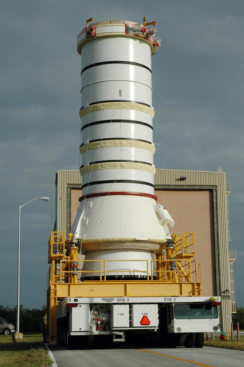 KENNEDY SPACE CENTER, FLA.  —   The right aft booster, comprised of the aft skirt and the aft motor segment, leaves the Rotation Processing and Surge Facility for transfer to the Vehicle Assembly Building where it will be lifted onto the mobile launcher platform.  The booster is being assembled for the space shuttle Discovery on mission STS-121, the second space shuttle mission in the return-to-flight sequence. The booster assembly is a major milestone in the processing sequence that leads to launch.  The launch date is targeted no earlier than May.  Photo credit:  NASA/Jack Pfaller
