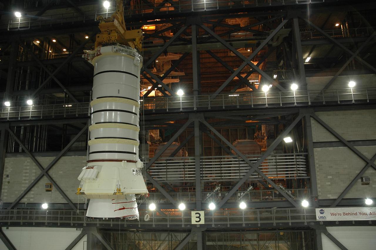 KENNEDY SPACE CENTER, FLA.  —   In the Vehicle Assembly Building at NASA Kennedy Space Center, an overhead crane lifts the right aft booster segments (aft skirt and aft motor segment).  The segments,  to be used with space shuttle Discovery on mission STS-121, will be installed on the mobile launcher platform in Bay 3.Mission STS-121 is the second space shuttle mission in the return-to-flight sequence.  The booster assembly is a major milestone in the processing sequence that leads to launch.  The launch date is targeted no earlier than May.  Photo credit:  NASA/Jack Pfaller