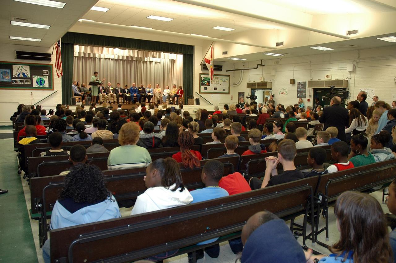 KENNEDY SPACE CENTER, FLA.  — Christine Nixon, principal of Warrington Middle School in Pensacola, Fla., introduces guests on stage to the audience of students and faculty.  The occasion is the kickoff of the NASA Explorer School program at the school. Among those seated on stage are Jim Paul, superintendent of Escambia County Schools; Denise Jamison, the school’s NASA Team facilitator; Les Gold, NASA aerospace specialist; Gregg Buckingham, NASA official; Jim Kennedy, director of Kennedy Space Center; Charles Baire, District representative, representing Congressman Jeff Miller; Letitia Wheeler, student at Warrington Middle School; and Alan Poindexter, NASA astronaut. Kennedy is visiting the school to share the vision for space exploration with the next generation.   He is talking with students about our destiny as explorers, NASA’s stepping stone approach to exploring Earth, the moon, Mars and beyond, how space impacts our lives, and how people and machines rely on each other in space.  NES establishes a three-year partnership annually between NASA and 50 NASA Explorer School teams, consisting of teachers and education administrators from diverse communities nationwide.  Photo credit: NASA/Cory Huston