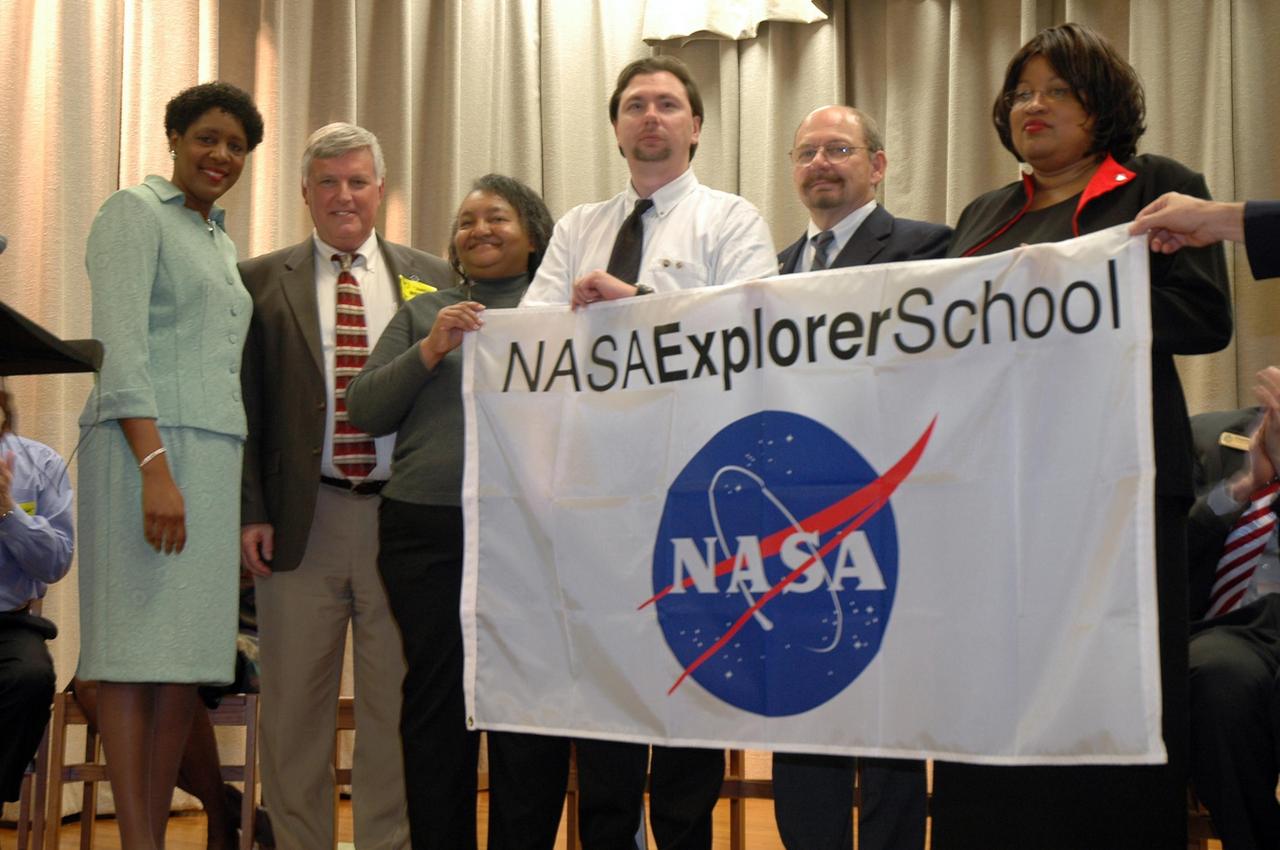 KENNEDY SPACE CENTER, FLA.  — Christine Nixon (left), principal of Warrington Middle School in Pensacola, Fla., joins Kennedy Space Center Jim Kennedy and the school’s NASA Explorer School team to recognize the new partnership with NASA. Kennedy is visiting the school to share the vision for space exploration with the next generation.   He is talking with students about our destiny as explorers, NASA’s stepping stone approach to exploring Earth, the moon, Mars and beyond, how space impacts our lives, and how people and machines rely on each other in space.  NES establishes a three-year partnership annually between NASA and 50 NASA Explorer School teams, consisting of teachers and education administrators from diverse communities nationwide.  Photo credit: NASA/Cory Huston