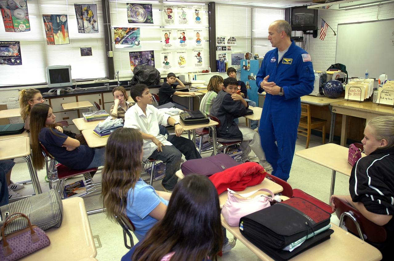 KENNEDY SPACE CENTER, FLA.  — At Warrington Middle School in Pensacola, Fla., astronaut Alan Poindexter talks to students.  Poindexter joined Center Director Jim Kennedy on a visit to the school, which has been named one of NASA’s Explorer Schools (NES).   Kennedy is visiting the school to share the vision for space exploration with the next generation.   He is talking with students about our destiny as explorers, NASA’s stepping stone approach to exploring Earth, the moon, Mars and beyond, how space impacts our lives, and how people and machines rely on each other in space.  NES establishes a three-year partnership annually between NASA and 50 NASA Explorer School teams, consisting of teachers and education administrators from diverse communities nationwide.  Photo credit: NASA/Cory Huston