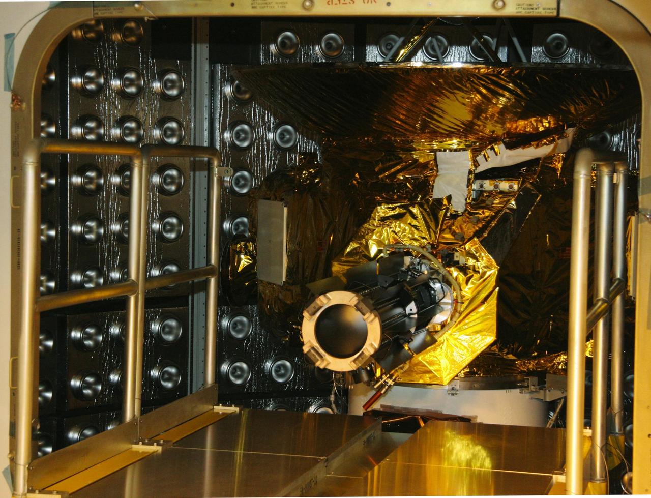 KENNEDY SPACE CENTER, FLA.  — On Complex 41 at Cape Canaveral Air Force Station in Florida, the radioisotope thermoelectric generator (RTG) is attached to the New Horizons spacecraft inside the fairing.  Designed and integrated at the Johns Hopkins University Applied Physics Laboratory (APL) in Laurel, Md., New Horizons will launch on a nine-and-a-half-year voyage to Pluto. Typical of RTG-based systems, as on past outer-planet missions, New Horizons does not have a battery for storing power. At the start of the mission, the RTG, which provides power through the natural radioactive decay of plutonium dioxide fuel, will supply approximately 240 watts (at 30 volts of direct current) - the spacecraft’s shunt regulator unit maintains a steady input from the RTG and dissipates power the spacecraft cannot use at a given time. By July 2015 (the earliest Pluto encounter date) that supply decreases to 200 watts at the same voltage, so New Horizons will ease the strain on its limited power source by cycling science instruments during planetary encounters.  On Complex 41 at Cape Canaveral Air Force Station in Florida, workers on the ground oversee the radioisotope thermoelectric generator (RTG) being lifted into the Vertical Integration Facility.  The RTG will be installed on the New Horizons spacecraft within the fairing at the top of the Atlas V launch vehicle.  Designed and integrated at the Johns Hopkins University Applied Physics Laboratory (APL) in Laurel, Md., New Horizons will launch on a nine-and-a-half-year voyage to Pluto. Typical of RTG-based systems, as on past outer-planet missions, New Horizons does not have a battery for storing power. At the start of the mission, the RTG, which provides power through the natural radioactive decay of plutonium dioxide fuel, will supply approximately 240 watts (at 30 volts of direct current) - the spacecraft’s shunt regulator unit maintains a steady input from the RTG and dissipates power the spacecraft cannot use at a give