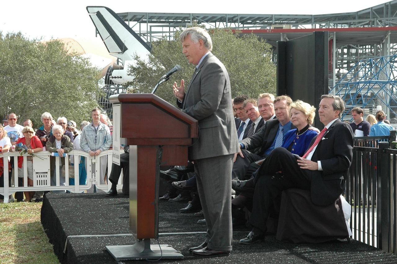 KENNEDY SPACE CENTER, FLA.  —  During the Challenger memorial ceremony held Jan. 28 in front of the Space Memorial Mirror at NASA Kennedy Space Center’s Visitor Complex, Center Director Jim Kennedy talks to visitors.  Others participating in the ceremony are Dr. Mick Ukleja, who gave the invocation; Dr. Stephen Feldman, president of the Astronauts Memorial Foundation; Rep. Dave Weldon and Rep. Tom Feeney;  William Potter, chairman of the Board of Directors of the Astronauts Memorial Foundation; William Gerstenmaier, associate administrator for Space Operations at NASA; June Scobee Rodgers, widow of Dick Scobee, commander of Challenger; Col. Richard Scobee, son of Dick Scobee and June Scobee Rodgers; Capt. Frederick Hauck, commander of the first mission after Challenger; Dr. Joseph Allen, astronaut and scientist and chairman of the Board of the Challenger Centers for Space Science.   June Scobee Rodgers and Gerstenmaier placed a wreath at the base of the memorial.  Photo credit:  NASA/Kim Shiflett