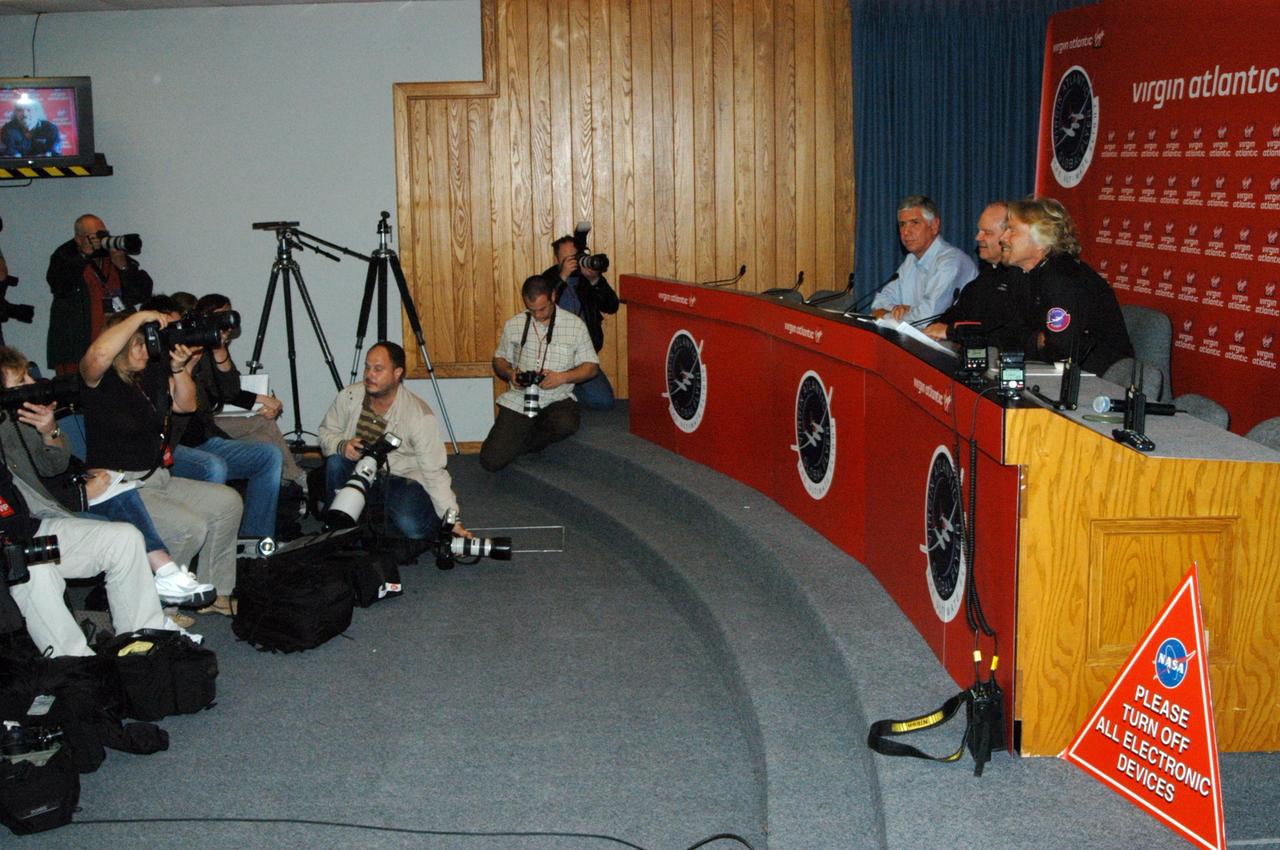 KENNEDY SPACE CENTER, FLA. -  The principals in the Virgin Atlantic GlobalFlyer long-distance attempt talk to the media gathered at a press conference held at NASA Kennedy Space Center’s television studio.  Seated from left are Jim Ball, manager of KSC Spaceport Development; Steve Fossett, the pilot; and Sir Richard Branson, chairman and founder of Virgin Atlantic.  Steve Fossett will pilot the GlobalFlyer on a record-breaking attempt by flying solo, non-stop without refueling, to surpass the current record for the longest flight of any aircraft.  Fossett is expected to take off from the KSC Shuttle Landing Facility early Tuesday morning.  Photo credit: NASA/George Shelton