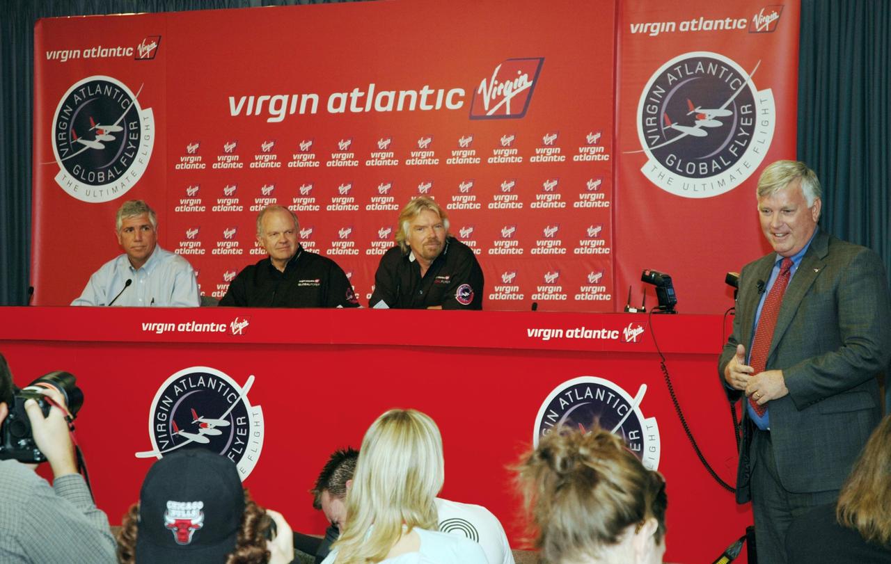KENNEDY SPACE CENTER, FLA. -  At a press conference at NASA Kennedy Space Center, Jim Kennedy (right), KSC director, introduces the principals in the Virgin Atlantic GlobalFlyer long-distance attempt.   Seated from left are Jim Ball, manager of KSC Spaceport Development; Steve Fossett, the pilot; and Sir Richard Branson, chairman and founder of Virgin Atlantic.  Steve Fossett will pilot the GlobalFlyer on a record-breaking attempt by flying solo, non-stop without refueling, to surpass the current record for the longest flight of any aircraft.  Fossett is expected to take off from the KSC Shuttle Landing Facility early Tuesday morning.  Photo credit: NASA/Jim Grossmann