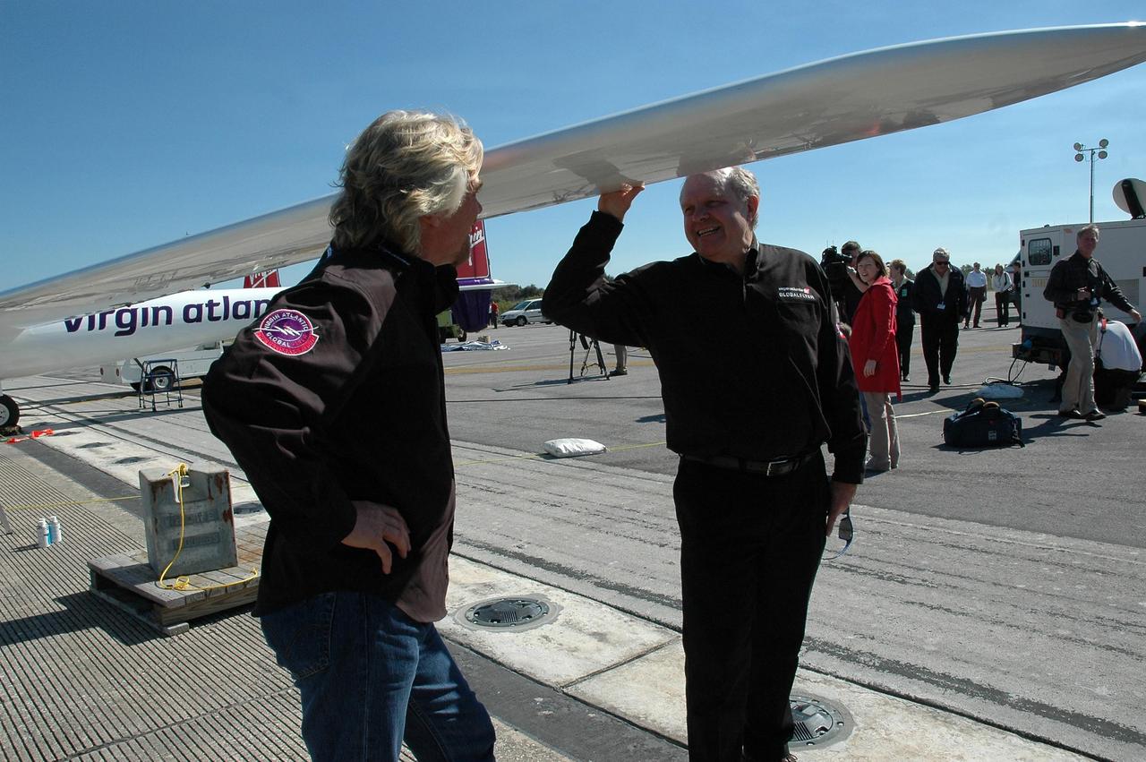KENNEDY SPACE CENTER, FLA. -  On NASA Kennedy Space Center’s Shuttle Landing Facility, Sir Richard Branson (left), chairman and founder of Virgin Atlantic, talks with Steve Fossett.  They are standing next to the Virgin Atlantic GlobalFlyer aircraft, which Fossett will pilot on a record-breaking attempt by flying solo, non-stop without refueling, to surpass the current record for the longest flight of any aircraft.  Fossett is expected to take off from the Shuttle Landing Facility early Tuesday morning.  Photo credit: NASA/Jack Pfaller
