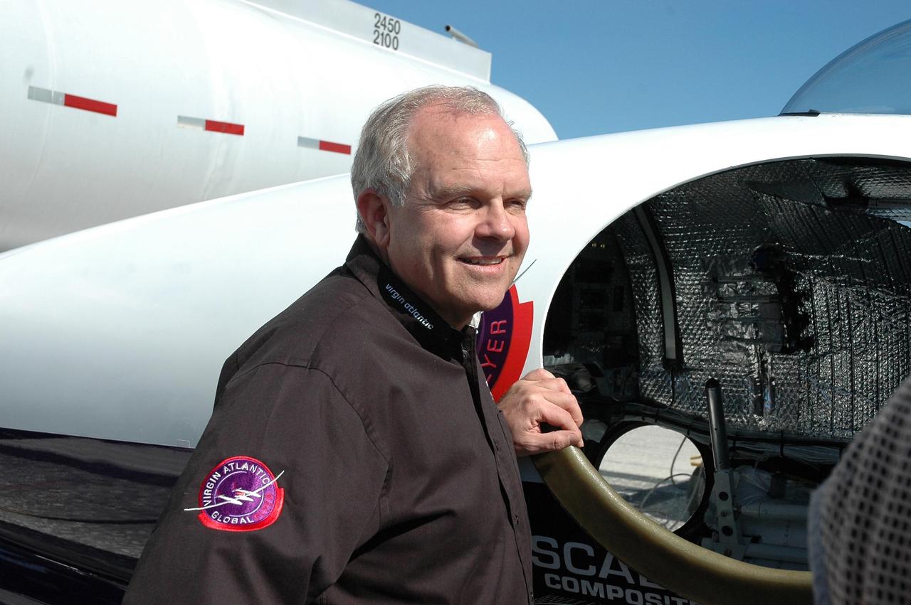 KENNEDY SPACE CENTER, FLA. -  On NASA Kennedy Space Center’s Shuttle Landing Facility, Steve Fossett stands next to the Virgin Atlantic GlobalFlyer aircraft.  Fossett will pilot the aircraft on a record-breaking attempt by flying solo, non-stop without refueling, to surpass the current record for the longest flight of any aircraft.  Fossett is expected to take off from the Shuttle Landing Facility early Tuesday morning.  Photo credit: NASA/Jack Pfaller