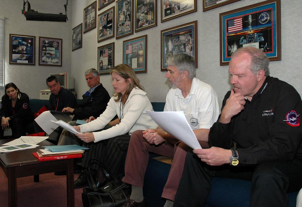 KENNEDY SPACE CENTER, FLA. -  On NASA Kennedy Space Center’s Shuttle Landing Facility, the Virgin Atlantic GlobalFlyer team gets a weather briefing.  Seated from right are Steve Fossett, the pilot; Ron Feile, lead air traffic controller at the Center’s Shuttle Landing Facility that will serve as the launch site; Kathy Winters, 45th Space Wing weather officer; Jim Ball, manager of KSC Spaceport Development; and other GlobalFlyer team members.  Fossett will pilot the aircraft on a record-breaking attempt by flying solo, non-stop without refueling, to surpass the current record for the longest flight of any aircraft.  Fossett is expected to take off from the Shuttle Landing Facility early Tuesday morning.  Photo credit: NASA/Jack Pfaller
