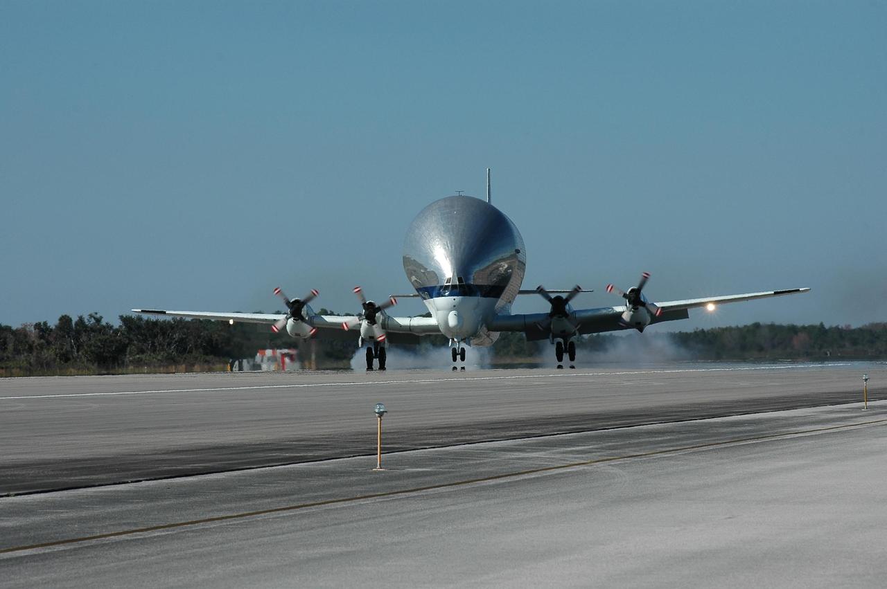 KENNEDY SPACE CENTER, FLA. - This Super Guppy aircraft touches down on the runway at NASA Kennedy Space Center’s Shuttle Landing Facility. It has flown to the Center to pick up and transport the common module structural test element to NASA's Marshall Space Flight Center in Huntsville, Ala. The common module is an aluminum canister used as a structural test element for an actual Space Station flight element. At Marshall, the module will be used to conduct advanced environmental control and life support testing for future NASA exploration missions. The Super Guppy aircraft has a unique hinged nose that can open more than 200 degrees, allowing large pieces of cargo to be loaded and unloaded from the front. Guppy aircraft were used in several past space programs, including Gemini, Apollo and Skylab, to transport spacecraft components. NASA personnel at Ellington Field outfitted the Super Guppy with a specially designed cradle to be used when carrying International Space Station components. The first Guppy aircraft was developed in 1962, designed specifically for NASA operations by Aero Spacelines of California. Photo credit: NASA/Kim Shiflett