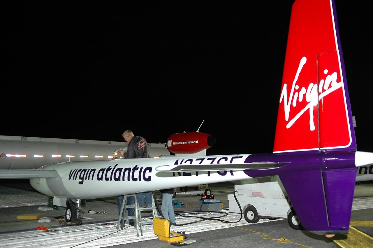 KENNEDY SPACE CENTER, FLA. -  Before dawn, the Virgin Atlantic GlobalFlyer is being fueled on NASA Kennedy Space Center’s Shuttle Landing Facility (SLF). Steve Fossett will pilot the GlobalFlyer on a record-breaking attempt by flying solo, non-stop without refueling, to surpass the current record for the longest flight of any aircraft.  Fossett is expected to take off from the KSC SLF.  Later, takeoff of the GlobalFlyer was postponed due to a fuel leak that appeared during the last moments of loading. The next planned takeoff attempt is 7 a.m. Feb. 8 from the SLF.   Photo credit: NASA/Kim Shiflett