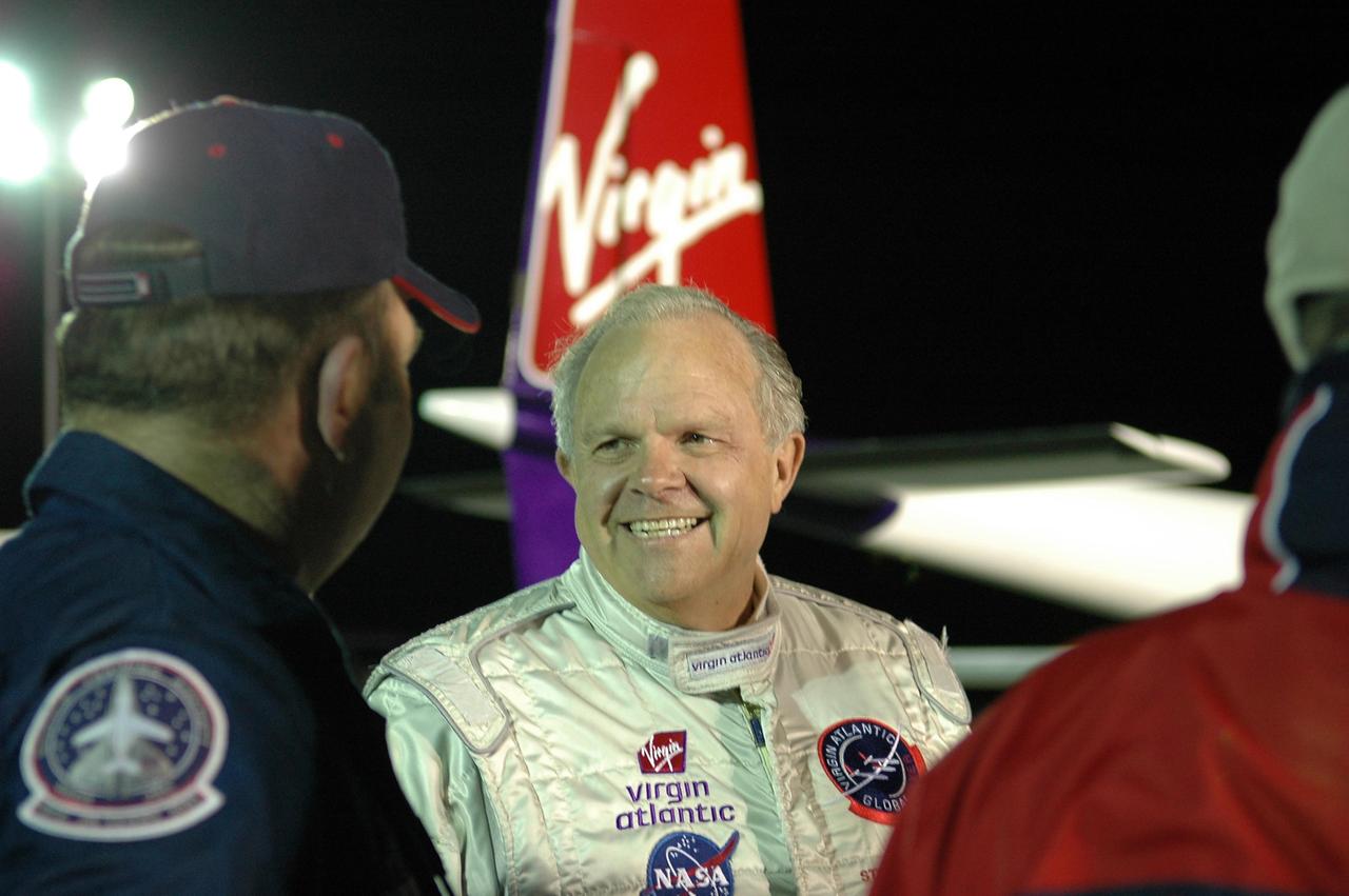 KENNEDY SPACE CENTER, FLA. -   Before dawn on NASA Kennedy Space Center’s Shuttle Landing Facility (SLF), Steve Fossett talks to the media about the anticipated flight of the Virgin Atlantic GlobalFlyer.  Fossett will pilot the GlobalFlyer on a record-breaking attempt by flying solo, non-stop without refueling, to surpass the current record for the longest flight of any aircraft.  Fossett is expected to take off from the KSC SLF.  Later, takeoff of the GlobalFlyer was postponed due to a fuel leak that appeared during the last moments of loading. The next planned takeoff attempt is 7 a.m. Feb. 8 from the SLF.   Photo credit: NASA/Kim Shiflett