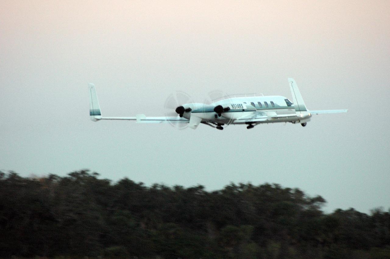 KENNEDY SPACE CENTER, FLA. -   A Beechcraft Starship aircraft precedes the takeoff of the Virgin Atlantic GlobalFlyer from NASA Kennedy Space Center’s Shuttle Landing Facility.  Photographers on board the Beachcraft will capture the historic event from the air.  Pilot Steve Fossett is attempting a record-breaking solo flight, non-stop without refueling, to surpass the current record for the longest flight of any aircraft. This is the second attempt in two days after a fuel leak was detected Feb. 7.  The actual launch time was 7:22 a.m. Feb. 8.