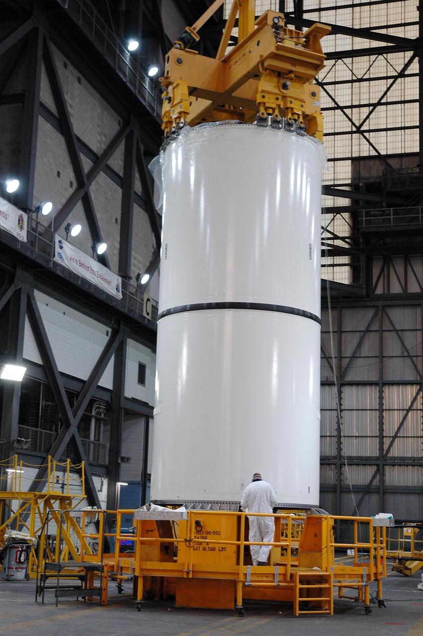 KENNEDY SPACE CENTER, FLA. -    Inside the Vehicle Assembly Building at NASA's Kennedy Space Center, a solid rocket booster segment is being lifted by a 325-ton crane for stacking.  The booster is part of the shuttle stack for Discovery and mission STS-121.  Launch of Discovery is scheduled for no earlier than May. Photo credit: NASA/Jack Pfaller