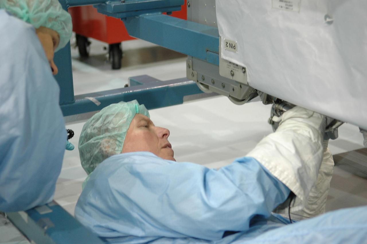 KENNEDY SPACE CENTER, FLA. -  In the Space Station Processing Facility at NASA Kennedy Space Center, STS-121 Mission Specialist Piers Sellers practices working with the replacement trailing umbilical system reel assembly that will be installed on the International Space Station.  He and other crew members -- Commander Steven Lindsey, Pilot Mark Kelly and Mission Specialists Lisa Nowak, Stephanie Wilson and Michael Fossum -- are at Kennedy to take part in the crew equipment interface test (CEIT).  The CEIT provides hands-on experiences with equipment used on-orbit.  Mission STS-121 is the second in the Return to Flight sequence and will carry on improvements that debuted during last year's STS-114 mission and build upon those tests.  Launch is scheduled in May.  Photo credit: NASA/Kim Shiflett