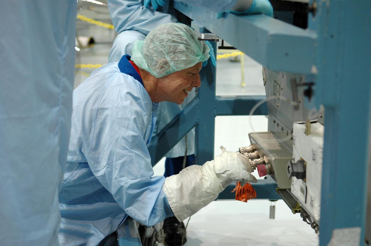 KENNEDY SPACE CENTER, FLA. -  In the Space Station Processing Facility at NASA Kennedy Space Center, STS-121 Mission Specialist Piers Sellers practices working with the replacement trailing umbilical system reel assembly that will be installed on the International Space Station.  He and other crew members -- Commander Steven Lindsey, Pilot Mark Kelly and Mission Specialists Lisa Nowak, Stephanie Wilson and Michael Fossum -- are at Kennedy to take part in the crew equipment interface test (CEIT).  The CEIT provides hands-on experiences with equipment used on-orbit.  Mission STS-121 is the second in the Return to Flight sequence and will carry on improvements that debuted during last year's STS-114 mission and build upon those tests.  Launch is scheduled in May.  Photo credit: NASA/Kim Shiflett
