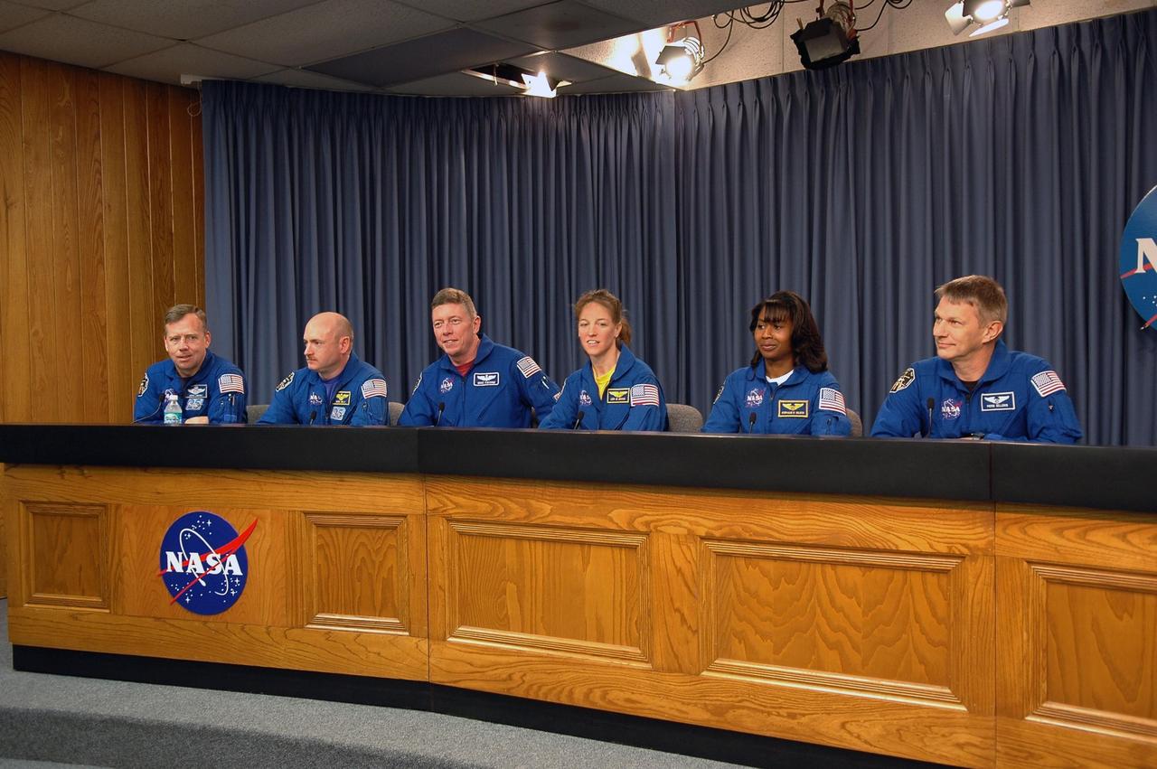 KENNEDY SPACE CENTER, FLA. -  In the television studio at NASA Kennedy Space Center, the STS-121 crew answers questions during a media conference.  Seated from left are Commander Steven Lindsey, Pilot Mark Kelly and Mission Specialists Michael Fossum, Lisa Nowak, Stephanie Wilson and Piers Sellers.  The seventh crew member, Mission Specialist Thomas Reiter, did not attend.  The crew is at NASA Kennedy Space Center for the crew equipment interface test, which provides hands-on experiences with equipment used on-orbit. The launch of STS-121, the second return-to-flight mission, is scheduled for May.   Photo credit: NASA/Kim Shiflett