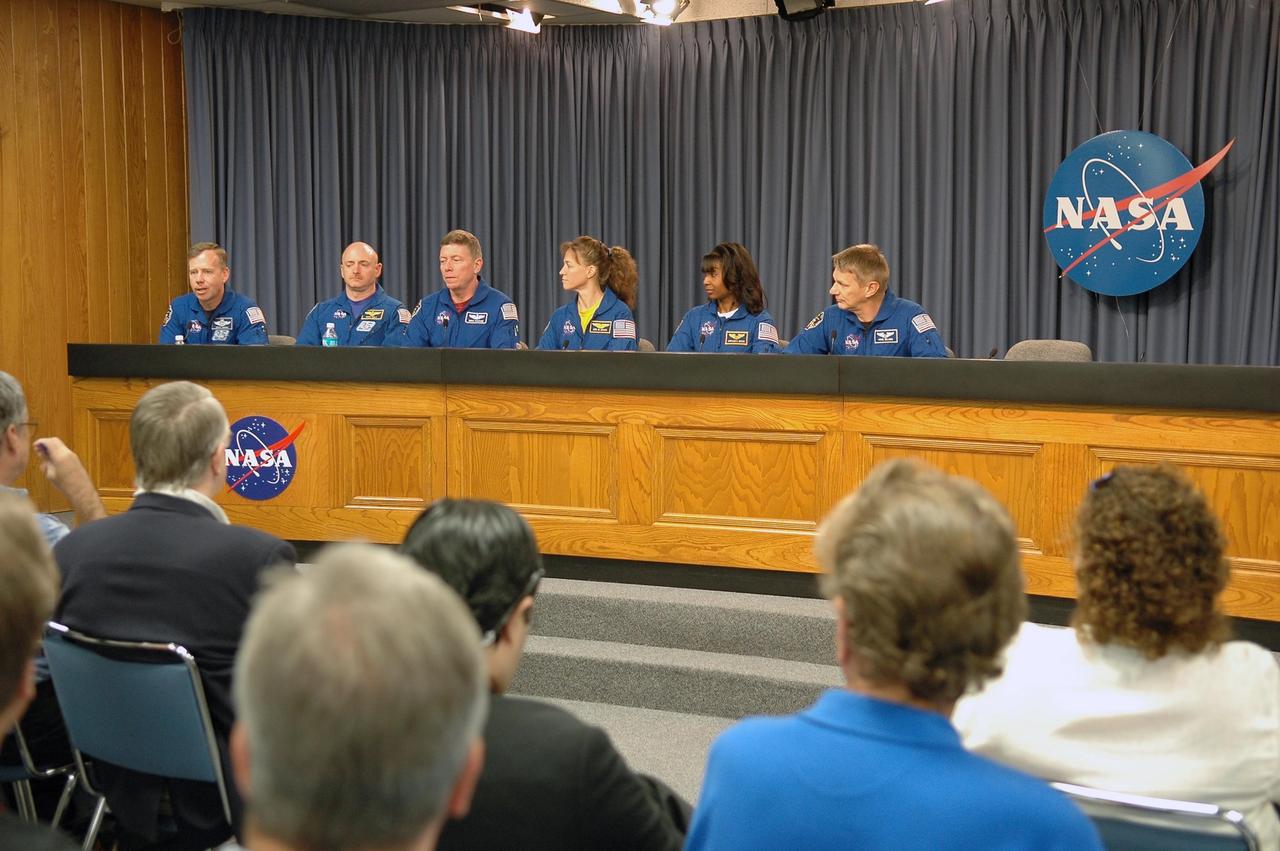 KENNEDY SPACE CENTER, FLA. -   In the television studio at NASA Kennedy Space Center, the STS-121 crew answers questions during a media conference.  Seated from left are Commander Steven Lindsey, Pilot Mark Kelly and Mission Specialists Michael Fossum, Lisa Nowak, Stephanie Wilson and Piers Sellers.  The seventh crew member, Mission Specialist Thomas Reiter, did not attend.  The crew is at NASA Kennedy Space Center for the crew equipment interface test, which provides hands-on experiences with equipment used on-orbit. The launch of STS-121, the second return-to-flight mission, is scheduled for May.   Photo credit: NASA/Kim Shiflett