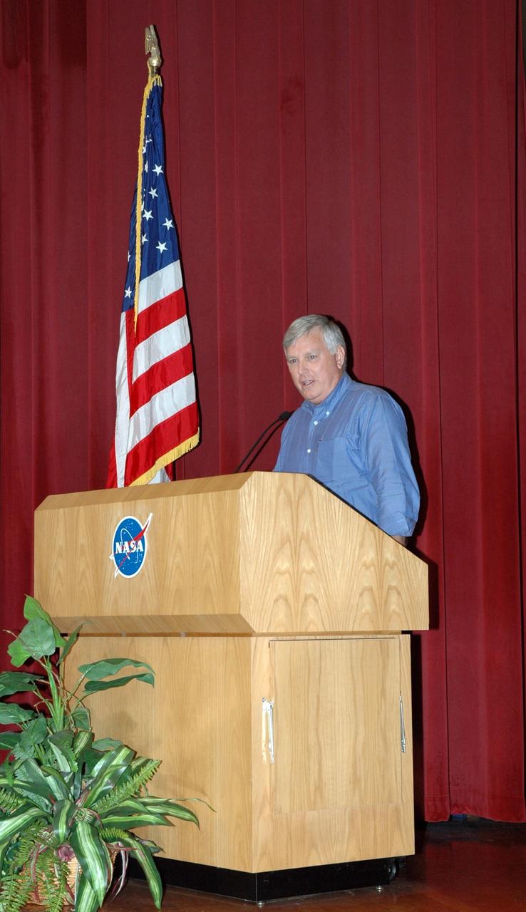 KENNEDY SPACE CENTER, FLA. - In the training auditorium at NASA's Kennedy Space Center, Center Director Jim Kennedy (at podium) welcomes Deputy Director Bill Parsons back to the center during a space shuttle all hands meeting.  Following Kennedy, Space Shuttle Program Manager Wayne Hale discussed the status of the program, successes of the STS-114 mission, effects of Hurricane Katrina on NASA facilities, and the newly released budget. Photo credit:  NASA/Jim Grossmann