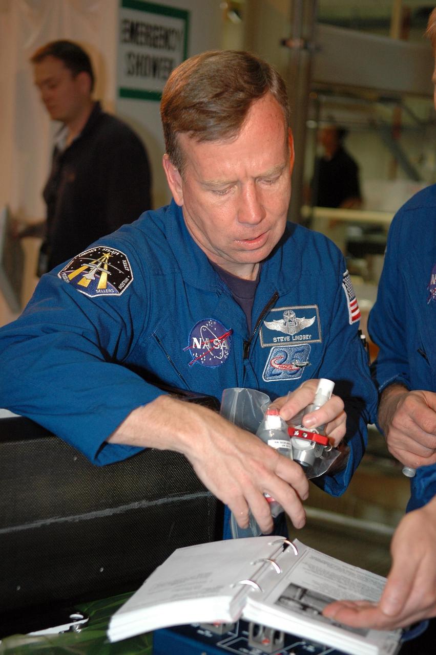 KENNEDY SPACE CENTER, FLA. - In NASA Kennedy Space Center's Orbiter Processing Facility bay 3, STS-121 Commander Steve Lindsey works with equipment that will be on the mission.  The crew is at Kennedy to take part in the crew equipment interface test, which provides hands-on experience with equipment to be used on-orbit.  Launch of Space Shuttle Discovery on mission STS-121, the second return-to-flight mission, is scheduled no earlier than May.
